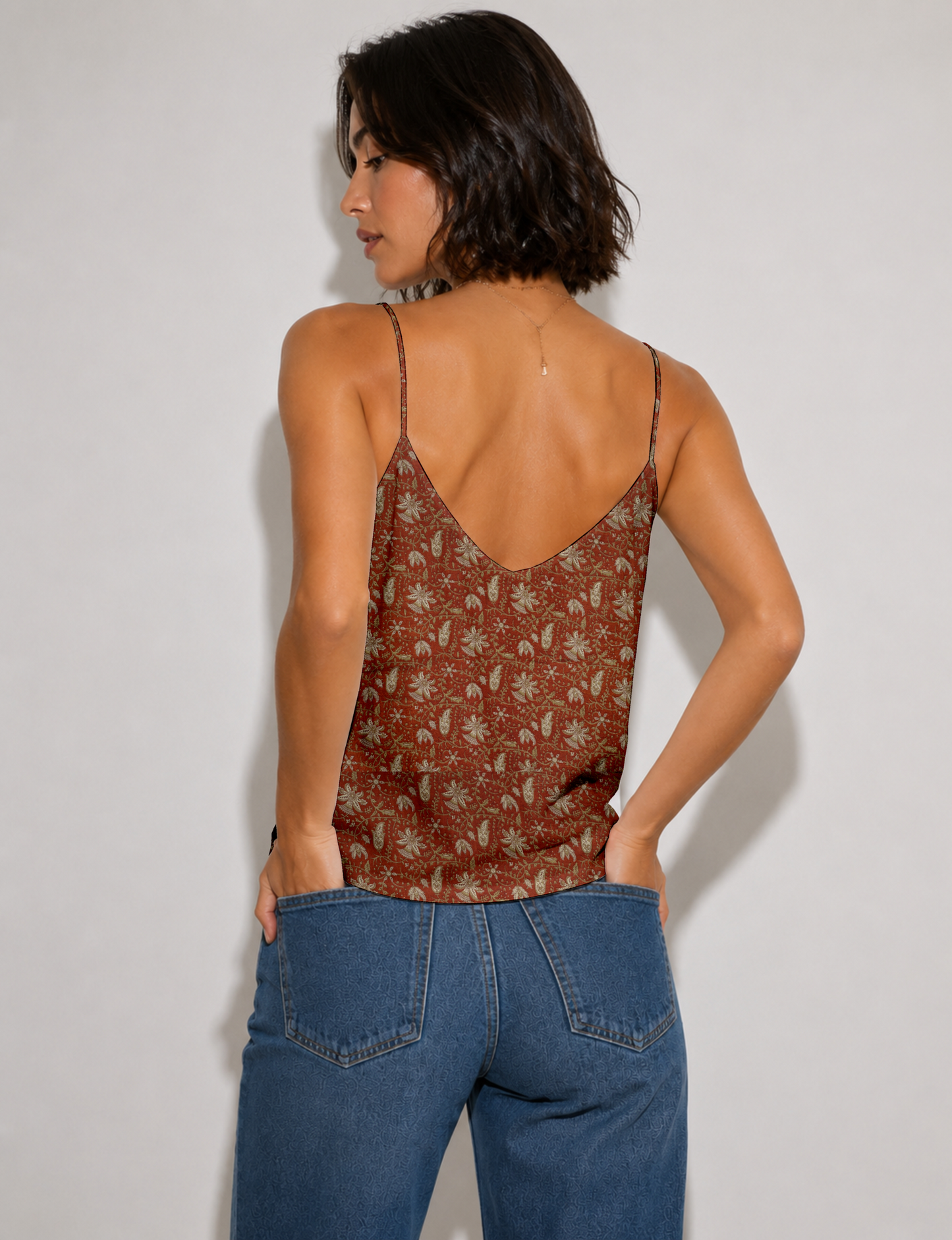 Women's sleeveless slip top with a relaxed straight fit, soft V-neckline, deep V-back, and delicate spaghetti straps.
