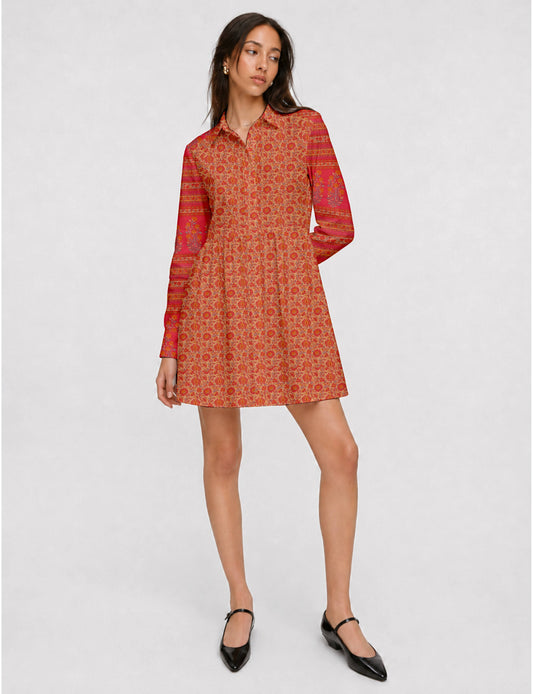 Short shirt dress with a relaxed A-line silhouette, point collar, partial button placket, gathered waist, side pockets, and full-length cuffed sleeves.