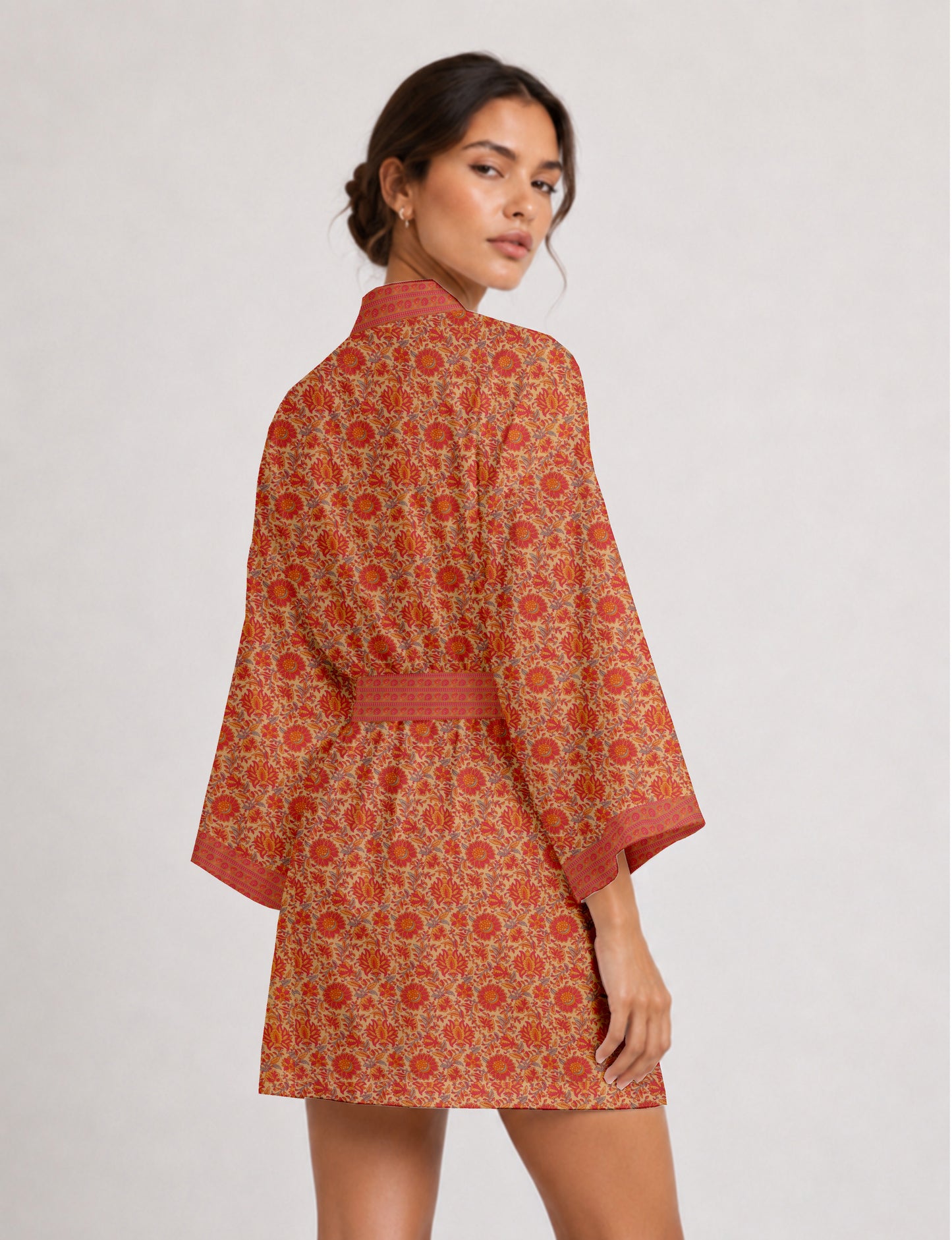 Short kimono robe with wrap front, V-neckline, wide sleeves, waist tie, and concealed skort detail.