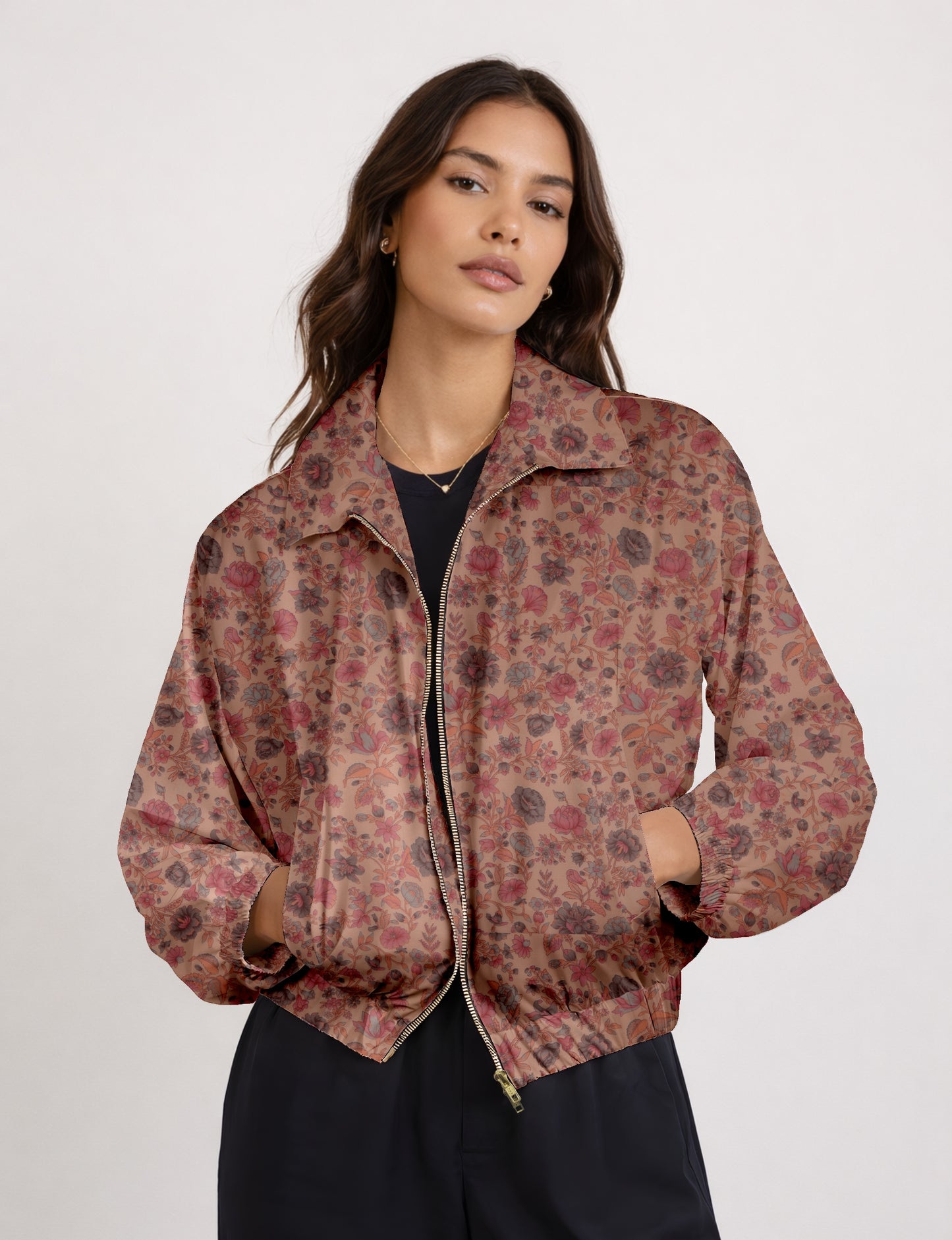Women's cropped bomber jacket with twin metallic front zippers, welt pockets, elasticated hem and cuffs, and contrast sari print lining.