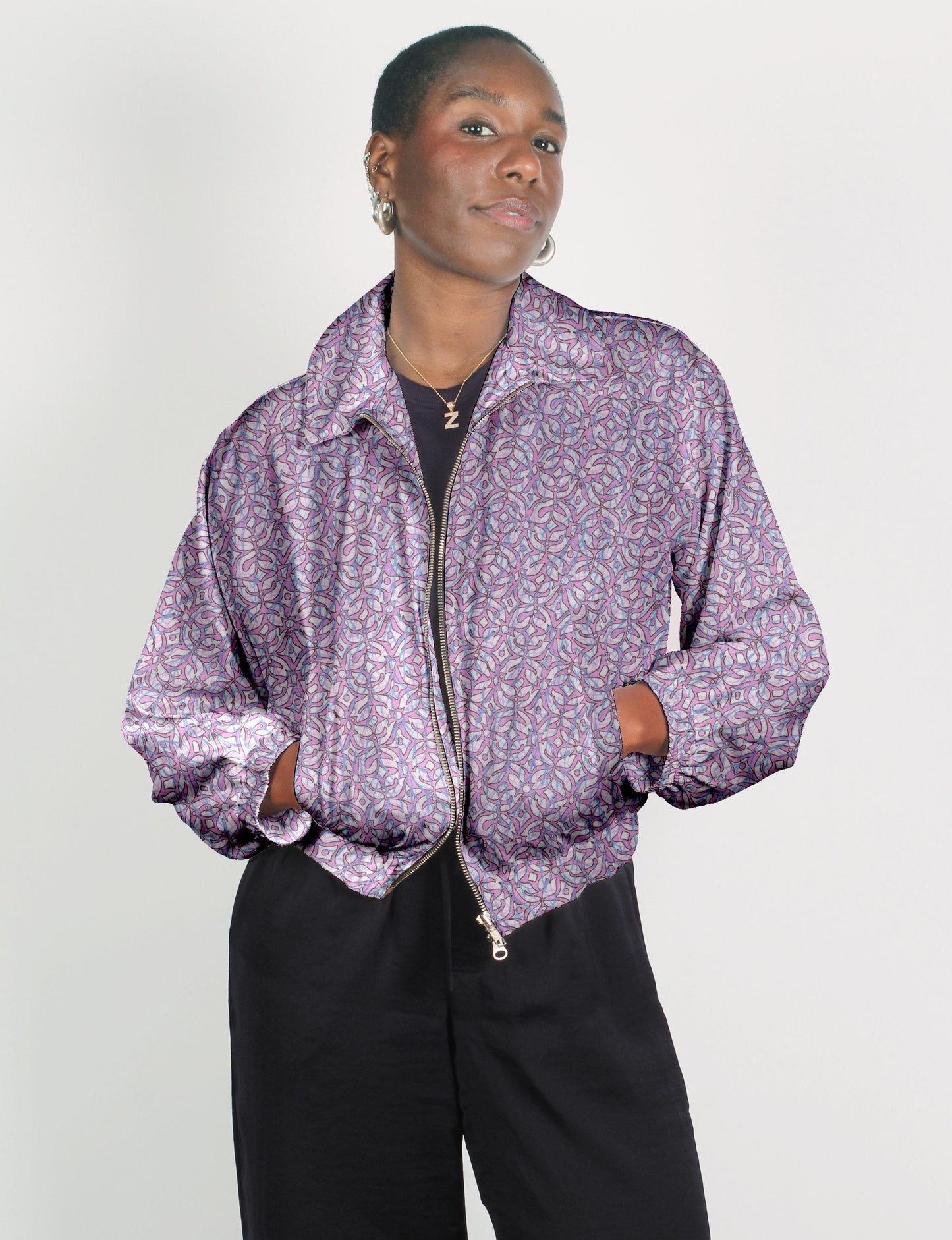 Upcycled Bomber Jacket made from recycled sari materials, featuring a cute cropped shape, elasticated hem and cuffs, and contrast sari print lining. Sustainable apparel promoting eco-friendly fashion and ethical clothing.