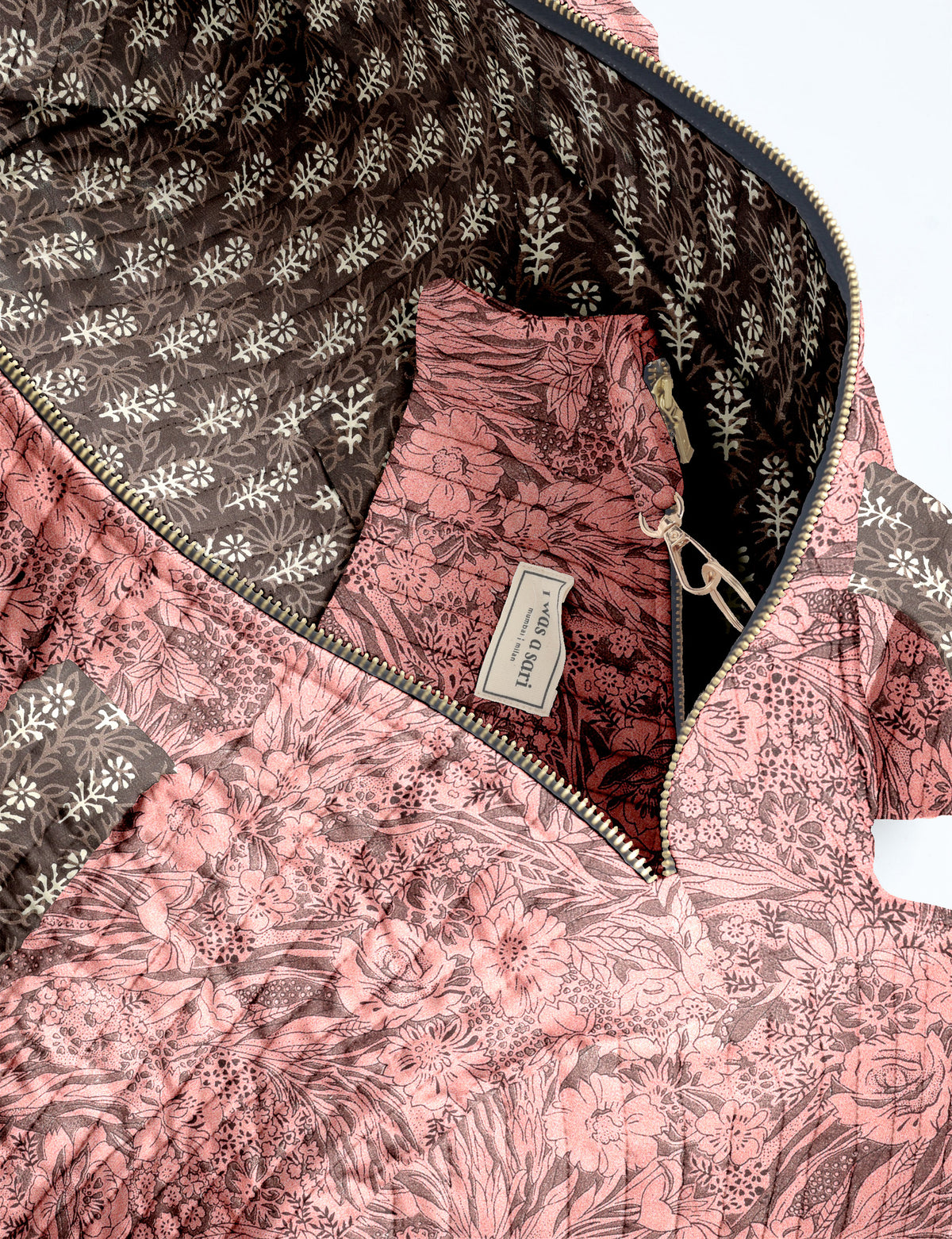 Brown paisley quilted bowling bag with dual handles, front zipper pocket, and "I was a sari" label on front side