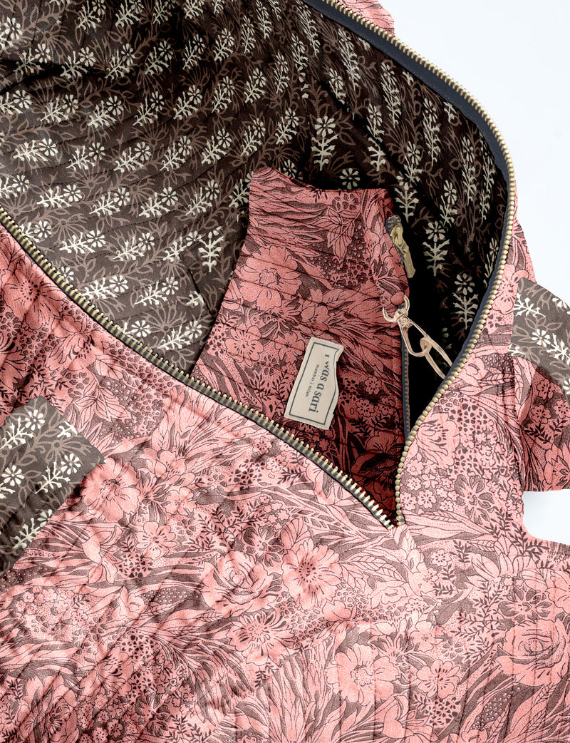 Brown paisley quilted bowling bag with dual handles, front zipper pocket, and "I was a sari" label on front side