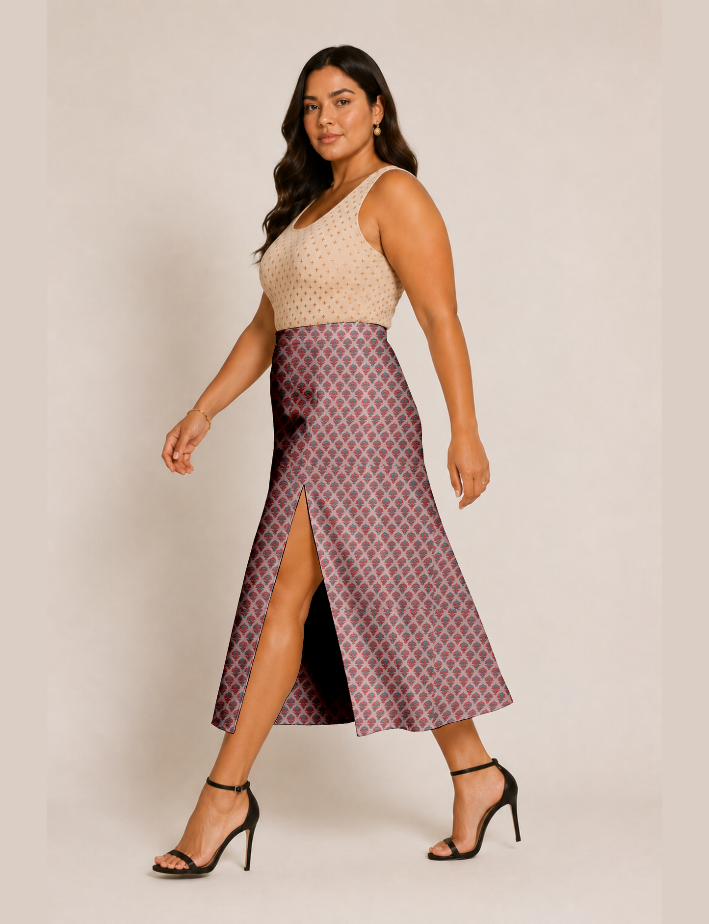 Woman wearing a yellow and black micro patterned A-line skirt with front slit, paired with beige sleeveless top and black