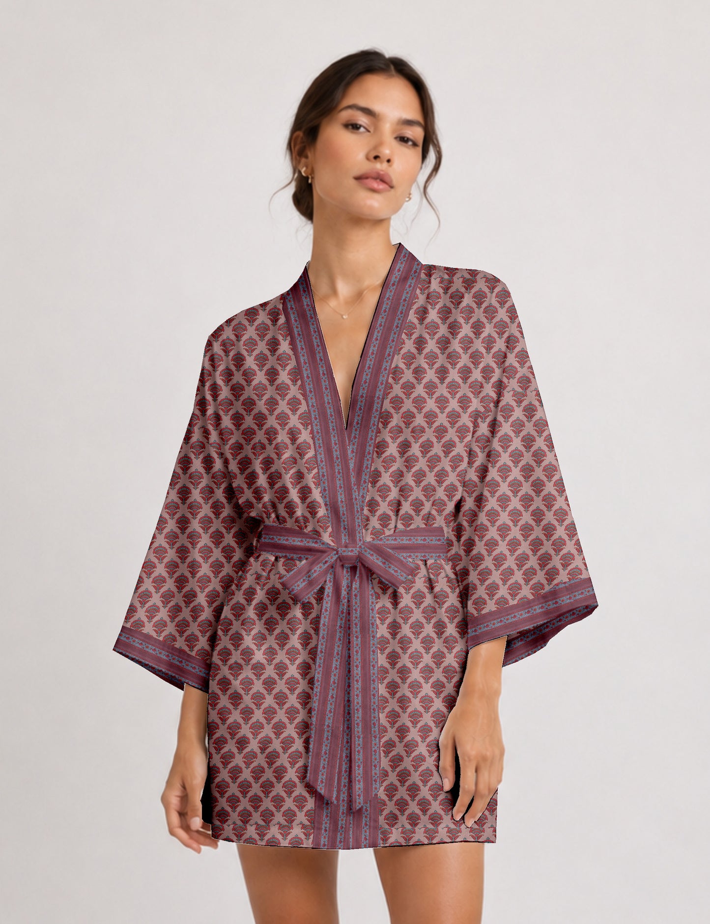 Short kimono robe with wrap front, V-neckline, wide sleeves, waist tie, and concealed skort detail.