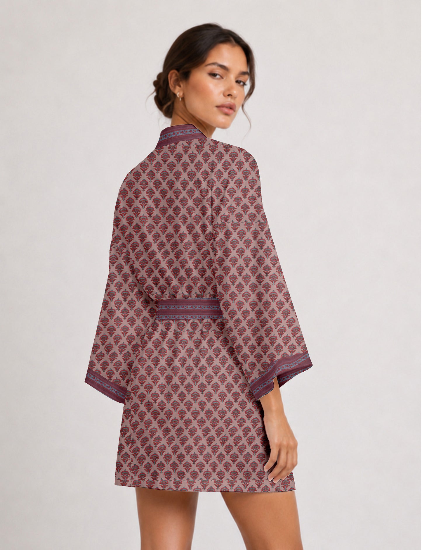 Short kimono robe with wrap front, V-neckline, wide sleeves, waist tie, and concealed skort detail.