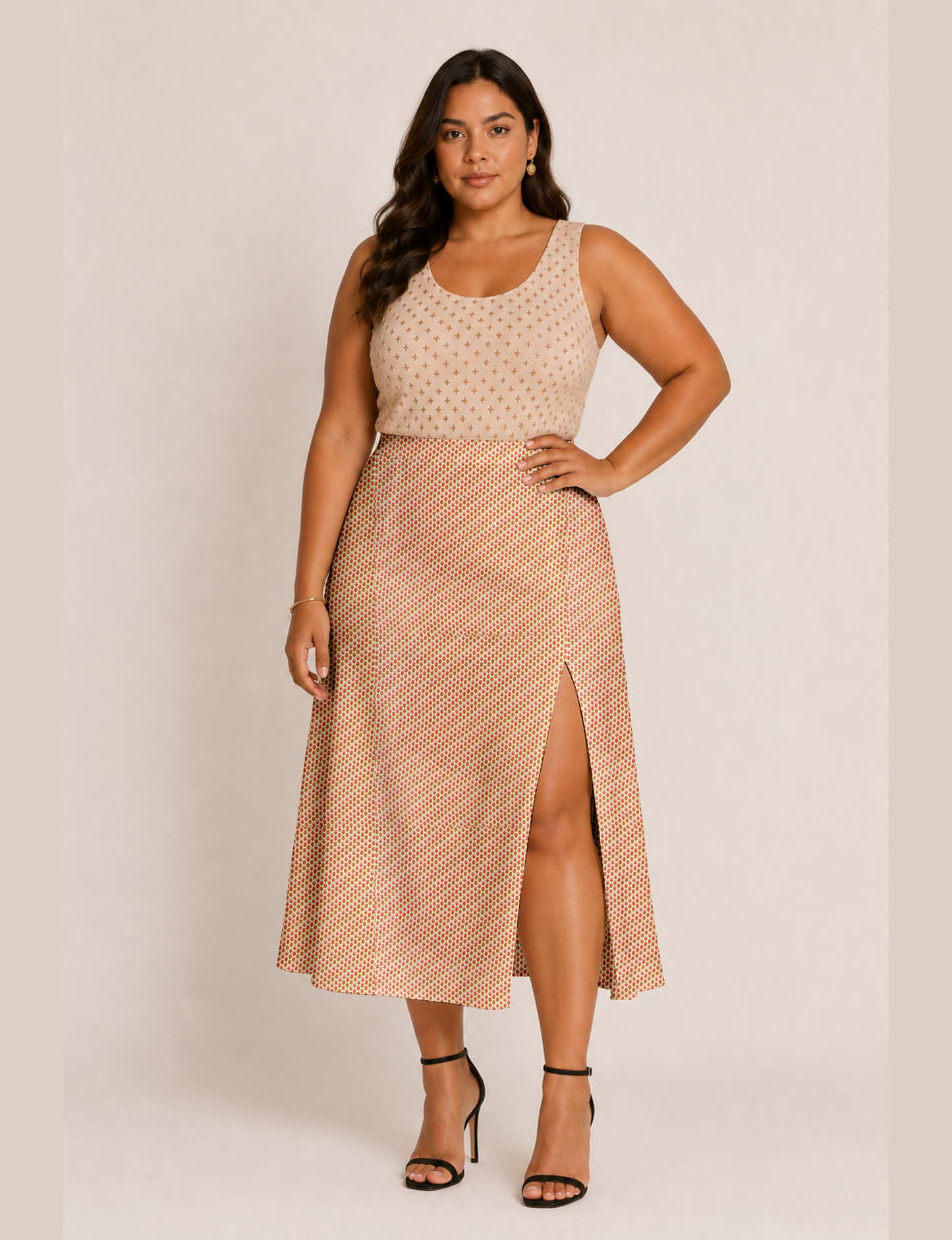 Woman wearing a yellow and black micro patterned A-line skirt with front slit, paired with beige sleeveless top and black