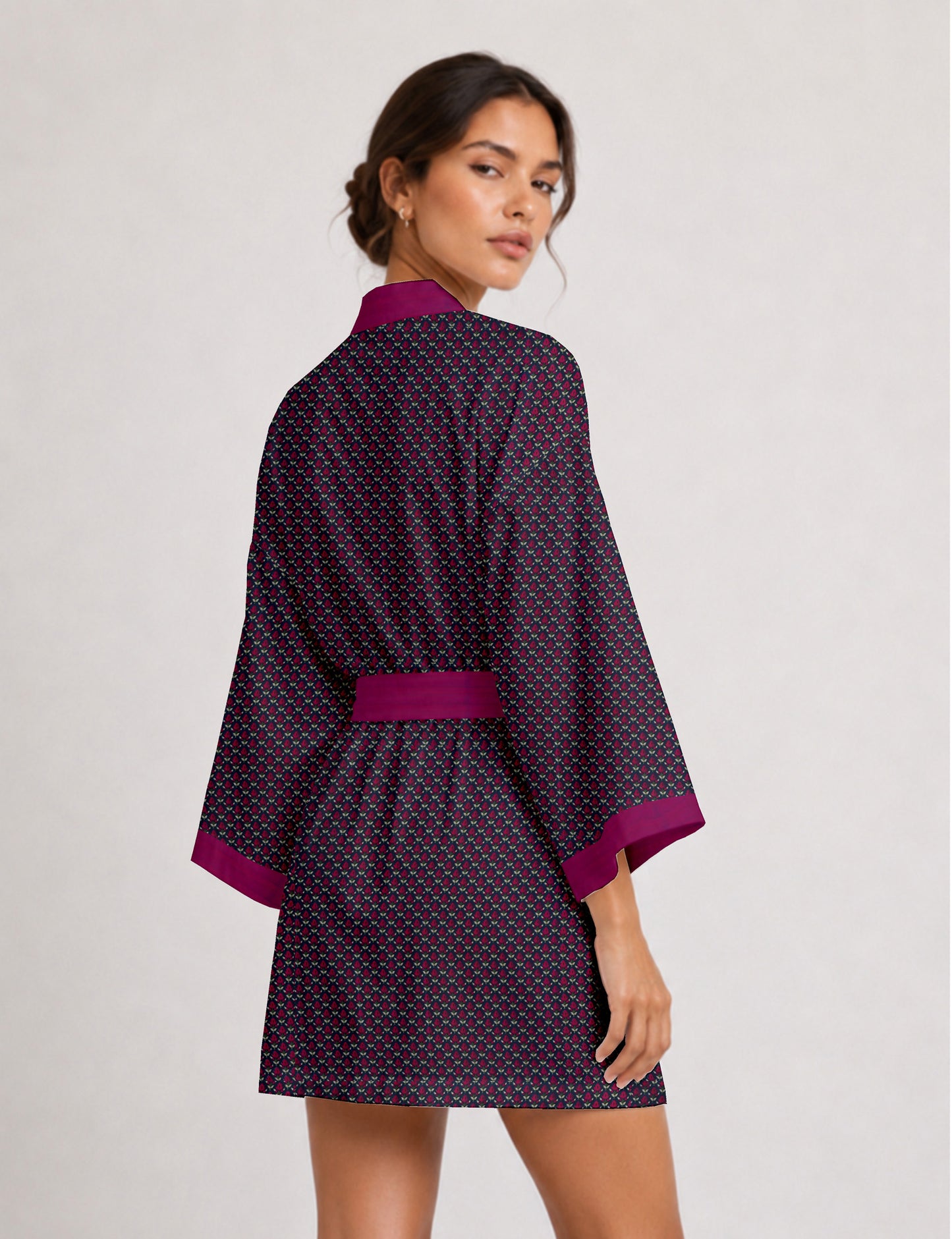 Short kimono robe with wrap front, V-neckline, wide sleeves, waist tie, and concealed skort detail.