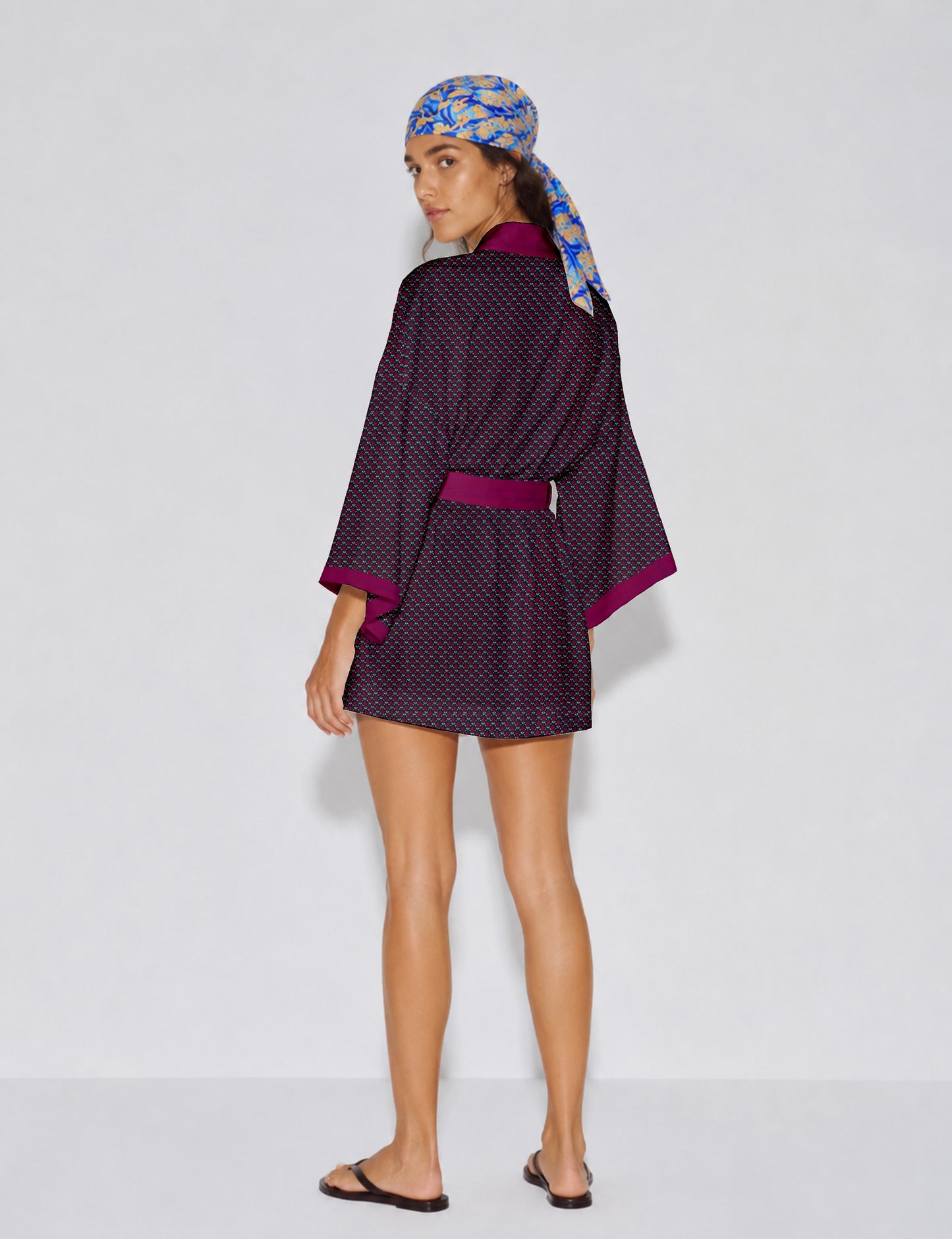 Short kimono robe with wrap front, V-neckline, wide sleeves, waist tie, and concealed skort detail.