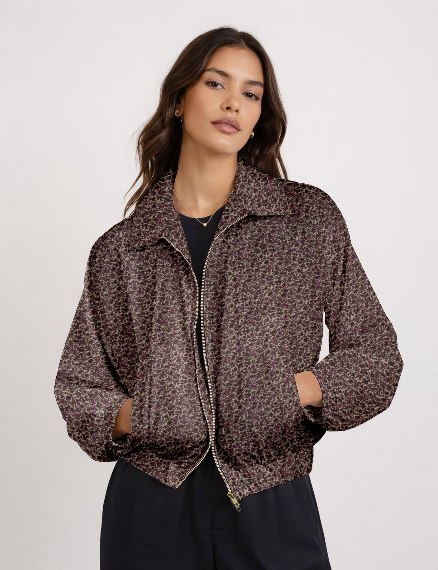 Woman wearing a yellow floral bomber jacket with front zipper, elastic cuffs, and side pockets, shown from front view