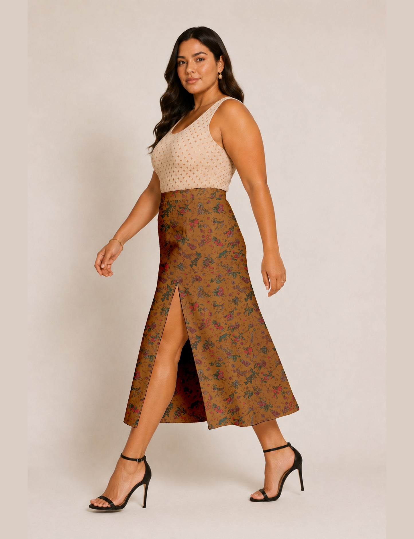 Woman wearing a yellow and black micro patterned A-line skirt with front slit, paired with beige sleeveless top and black