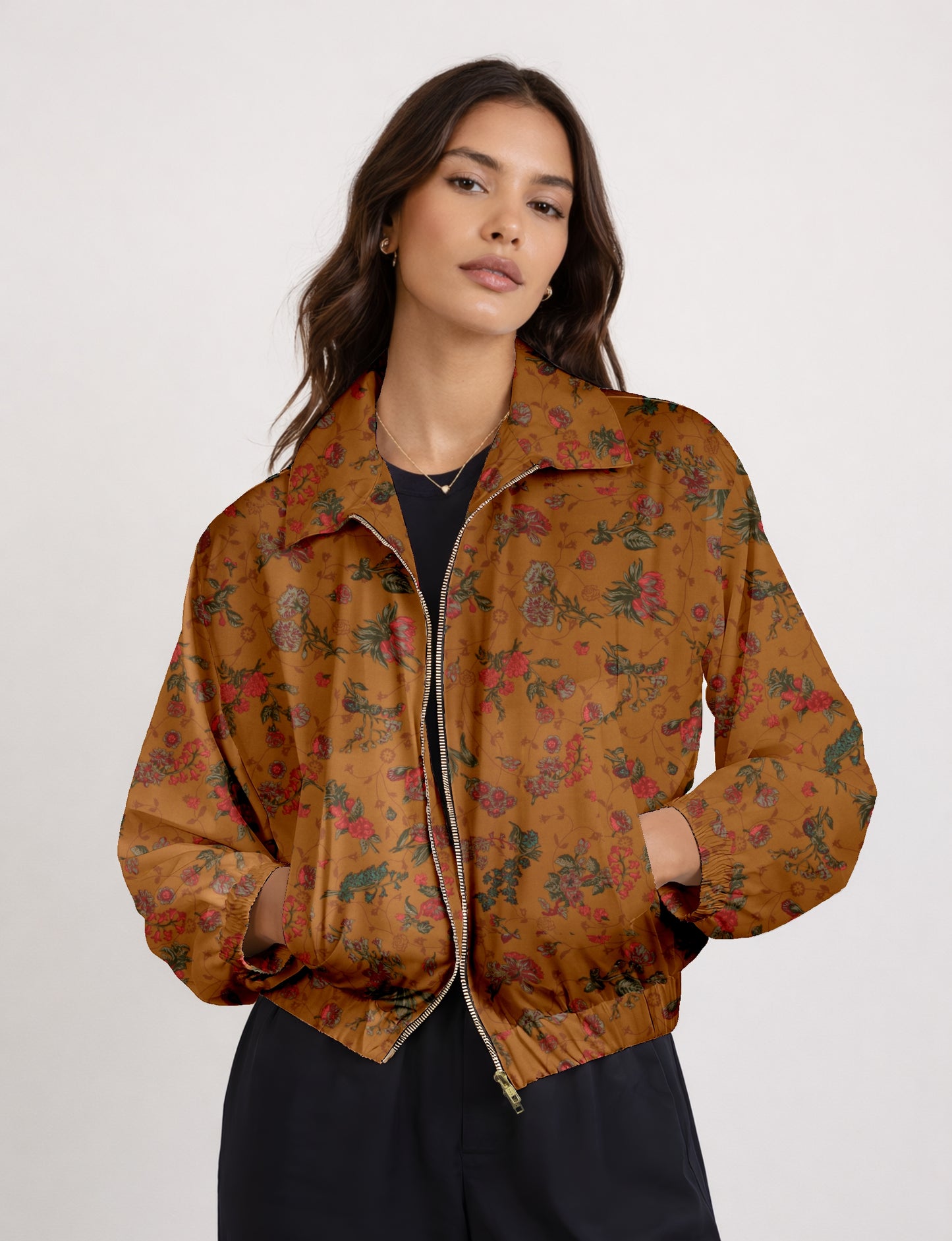 Woman wearing a yellow bomber jacket with a micro geometric pattern, front zipper, and side pockets, paired with black pants
