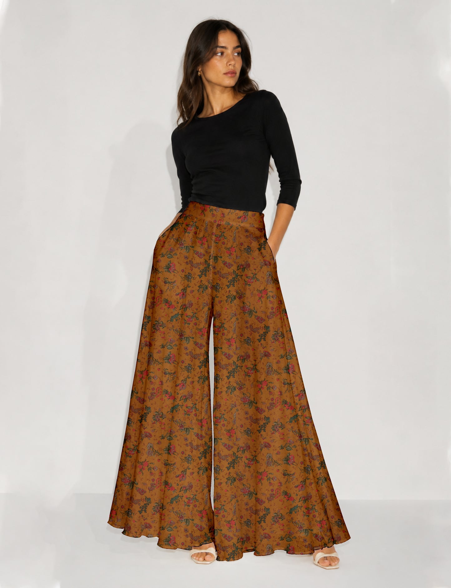Blue wide leg palazzo trousers with a small tropical floral pattern, flat lay front view