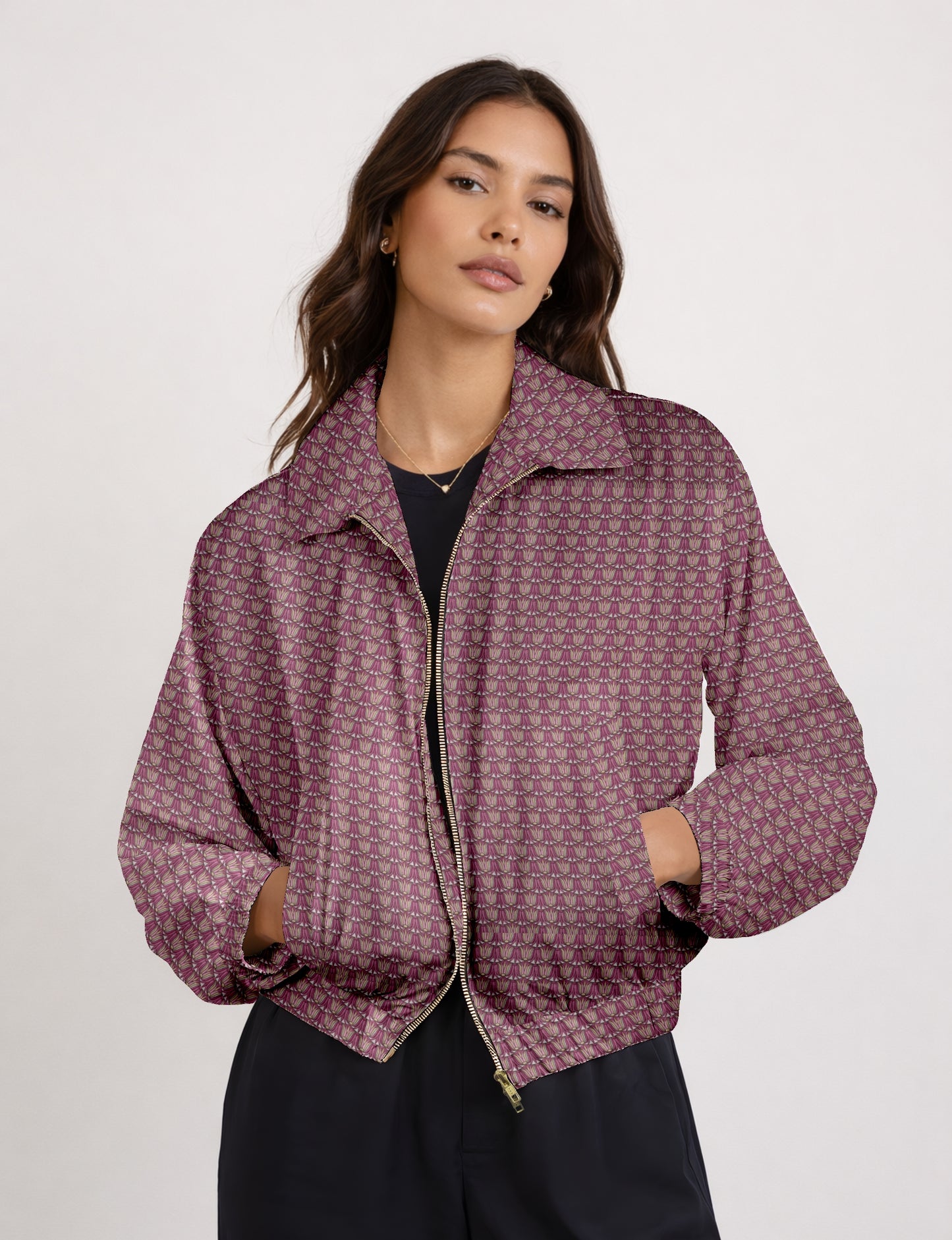 Women's cropped bomber jacket with twin metallic front zippers, welt pockets, elasticated hem and cuffs, and contrast sari print lining.