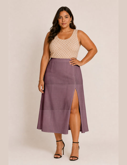 Woman wearing a yellow and black micro patterned A-line skirt with front slit, paired with beige sleeveless top and black