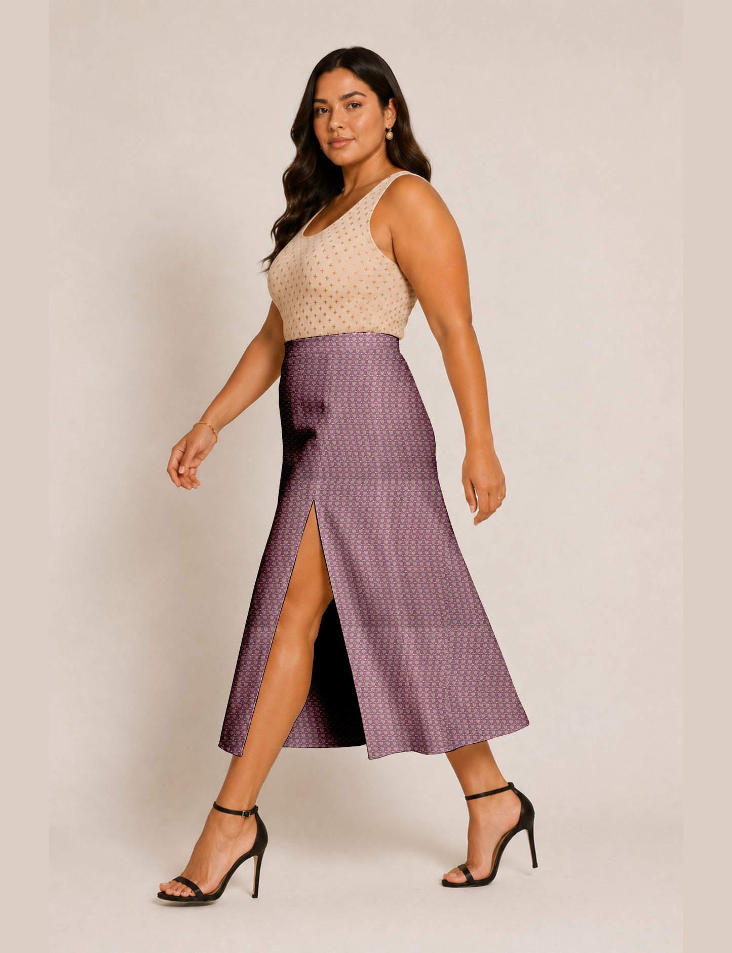 Woman wearing a yellow and black micro patterned A-line skirt with front slit, paired with beige sleeveless top and black