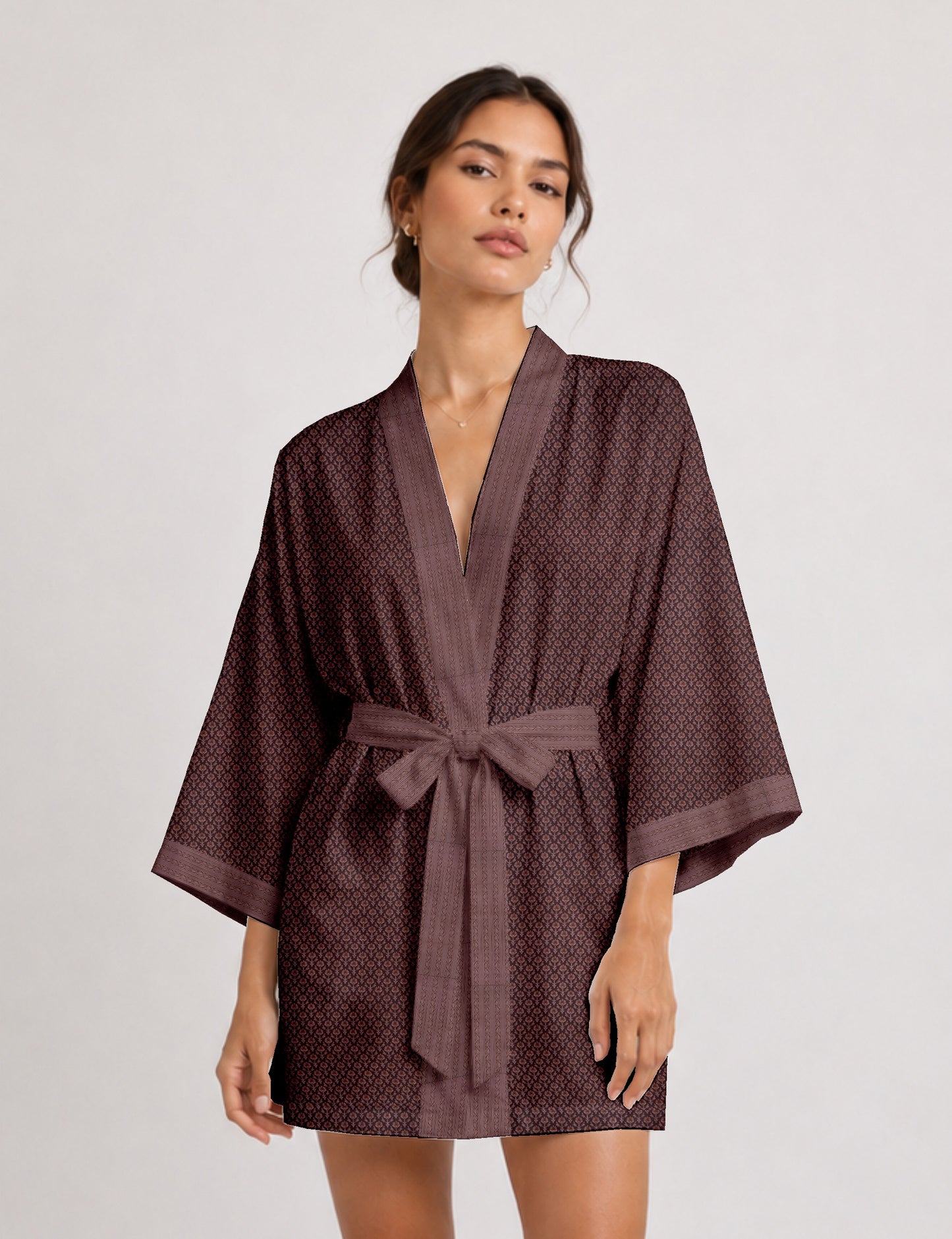Short kimono robe with wrap front, V-neckline, wide sleeves, waist tie, and concealed skort detail.
