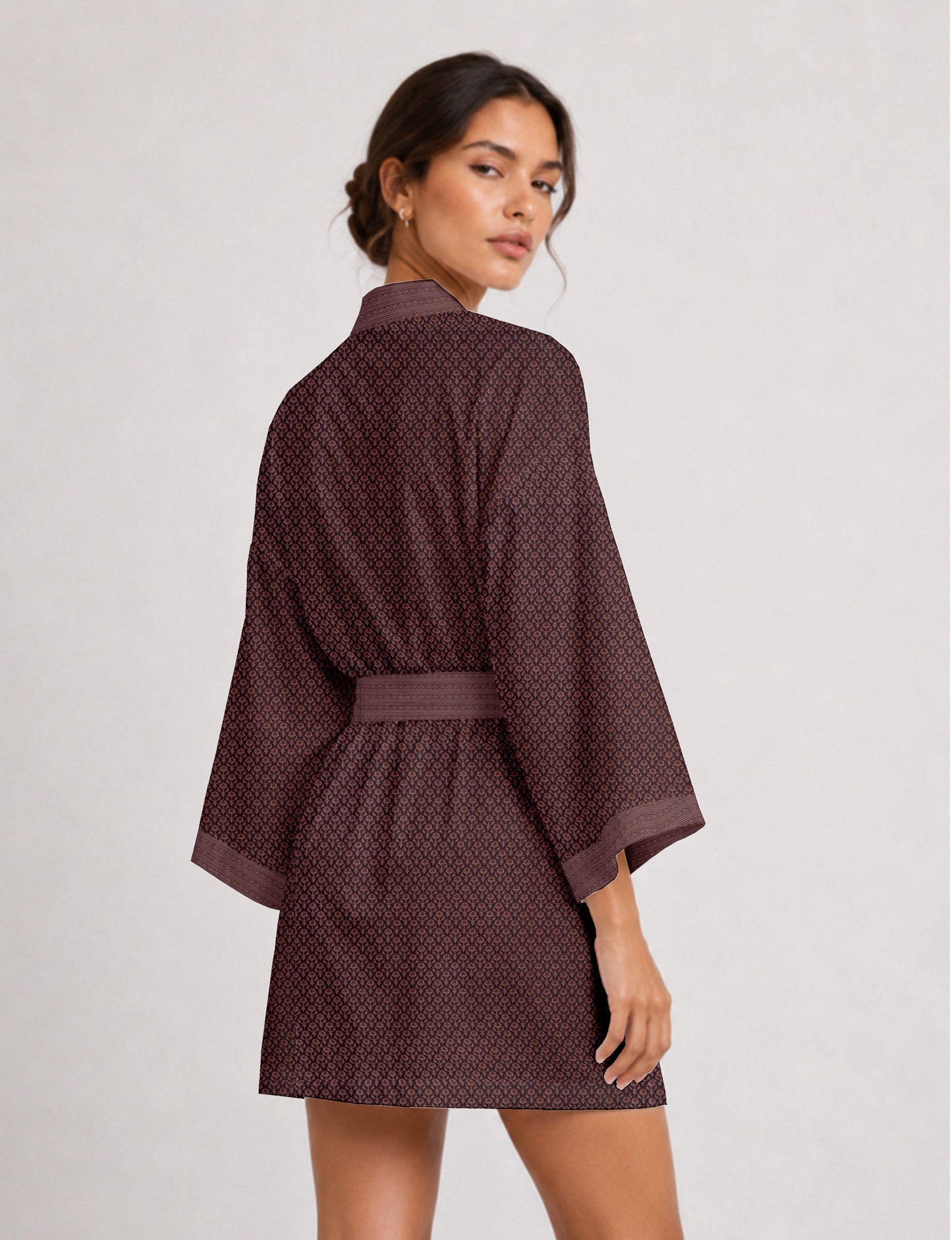 Short kimono robe with wrap front, V-neckline, wide sleeves, waist tie, and concealed skort detail.