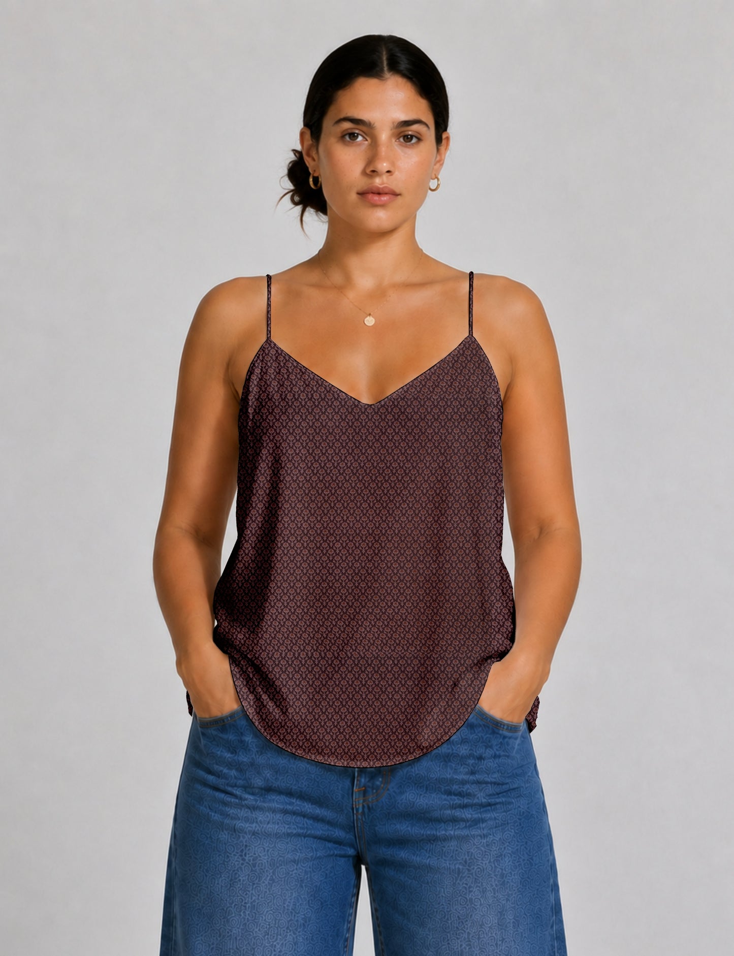 Women's sleeveless slip top with a relaxed straight fit, soft V-neckline, deep V-back, and delicate spaghetti straps.