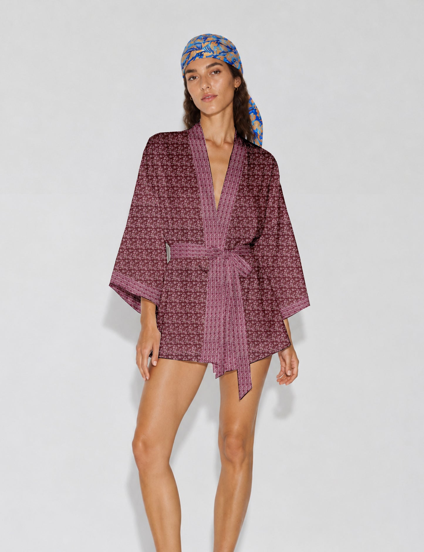 Short kimono robe with wrap front, V-neckline, wide sleeves, waist tie, and concealed skort detail.