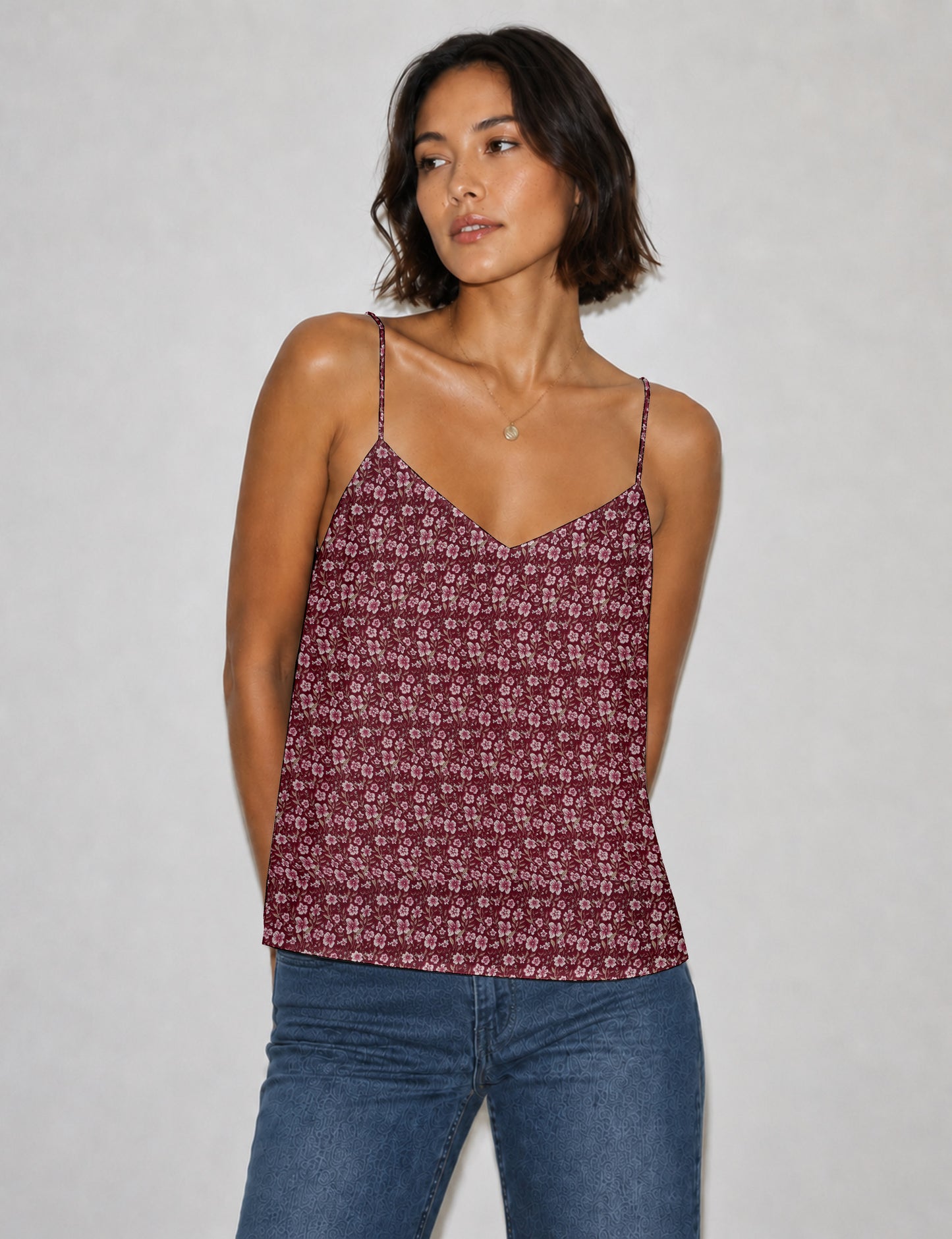 Women's sleeveless slip top with a relaxed straight fit, soft V-neckline, deep V-back, and delicate spaghetti straps.