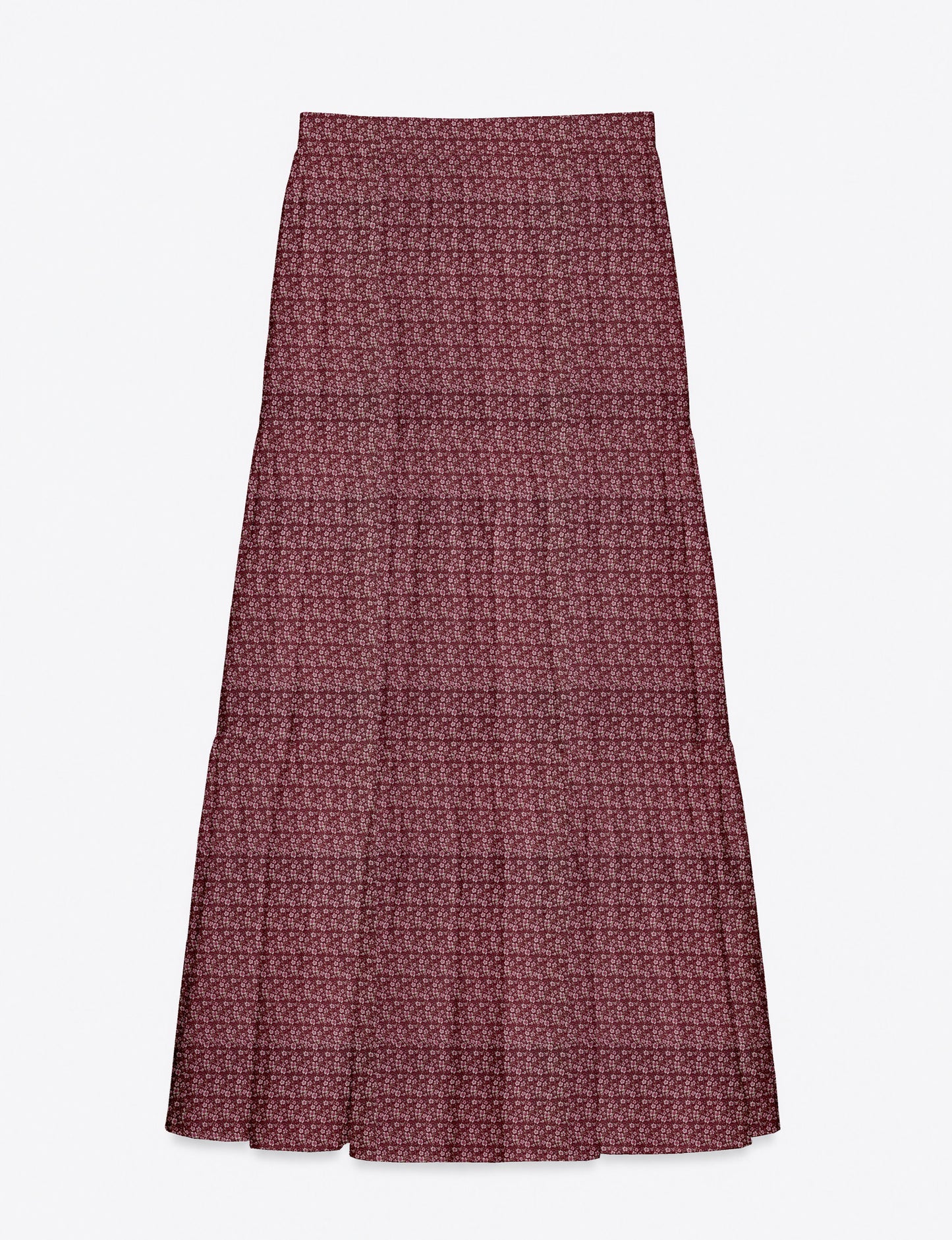 Woman wearing a yellow midi tiered skirt with a small geometric pattern, shown from the back, paired with beige top and