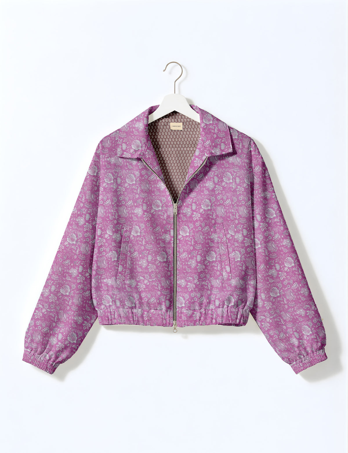 Woman wearing a yellow floral bomber jacket with front zipper, elastic cuffs, and side pockets, shown from front view
