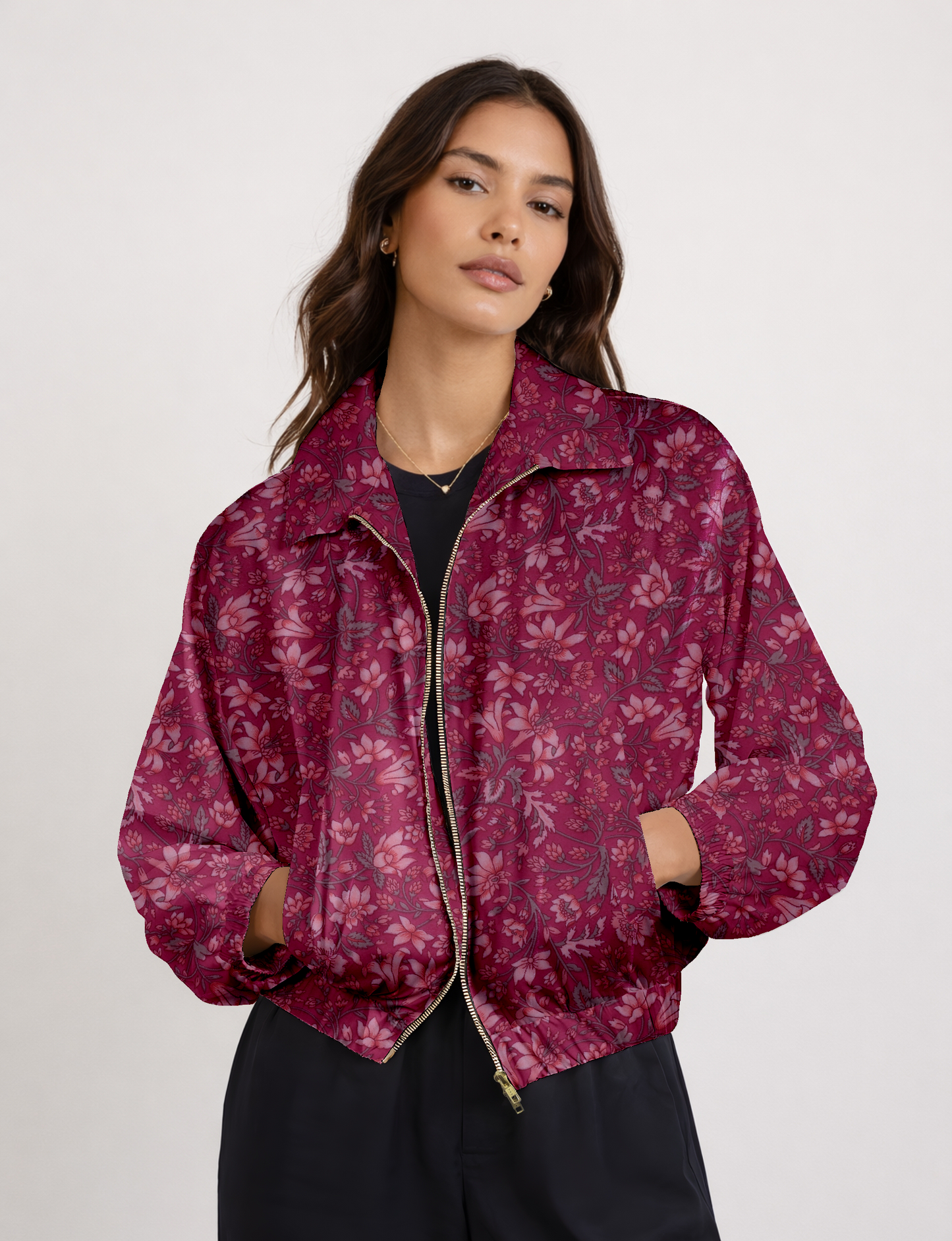 Women's cropped bomber jacket with twin metallic front zippers, welt pockets, elasticated hem and cuffs, and contrast sari print lining.