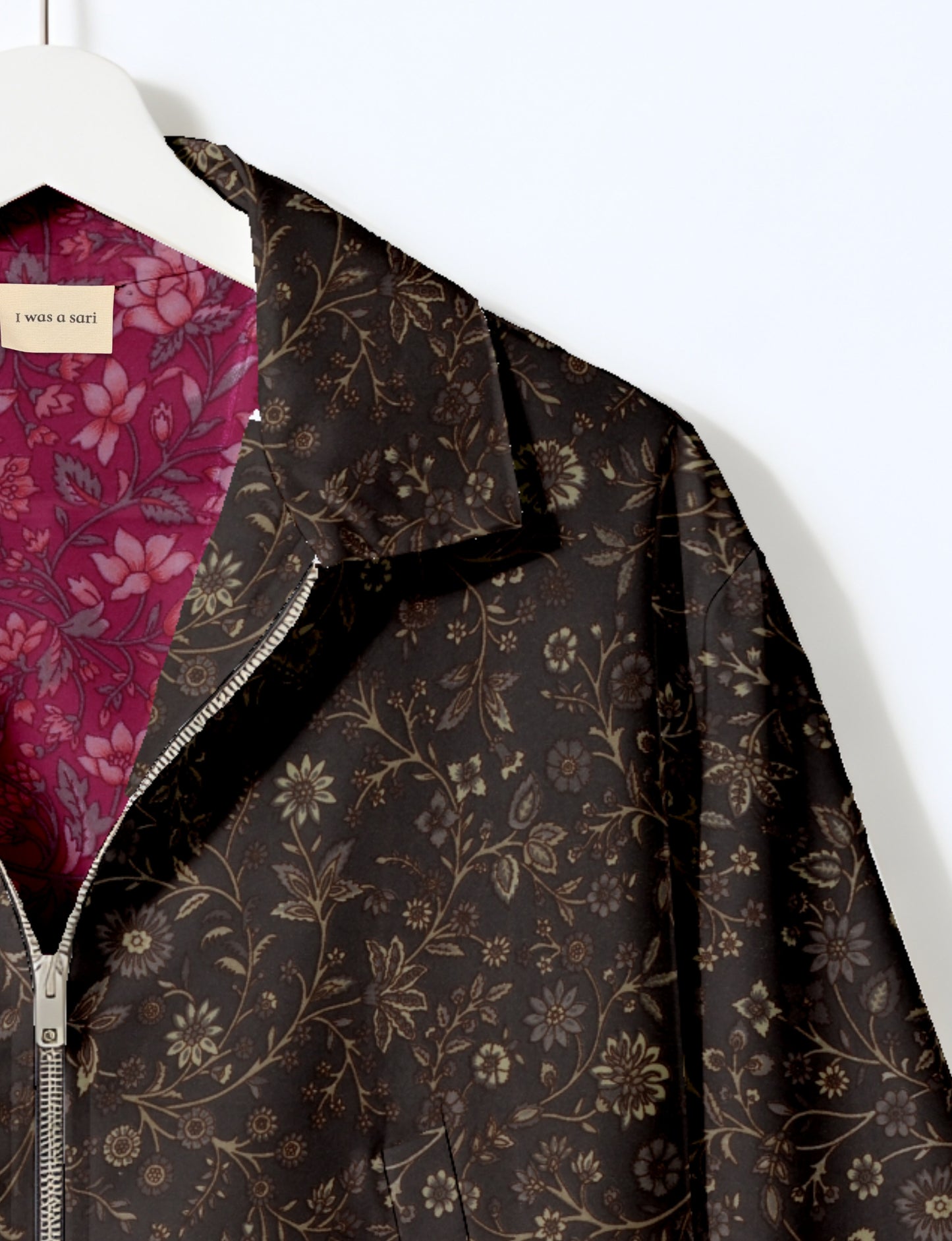 Women's cropped bomber jacket with twin metallic front zippers, welt pockets, elasticated hem and cuffs, and contrast sari print lining.