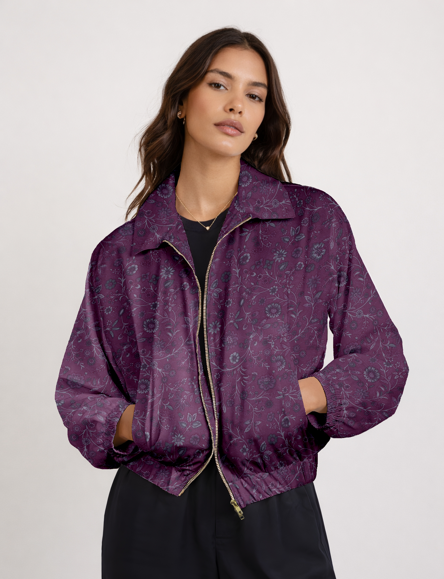 Women's cropped bomber jacket with twin metallic front zippers, welt pockets, elasticated hem and cuffs, and contrast sari print lining.