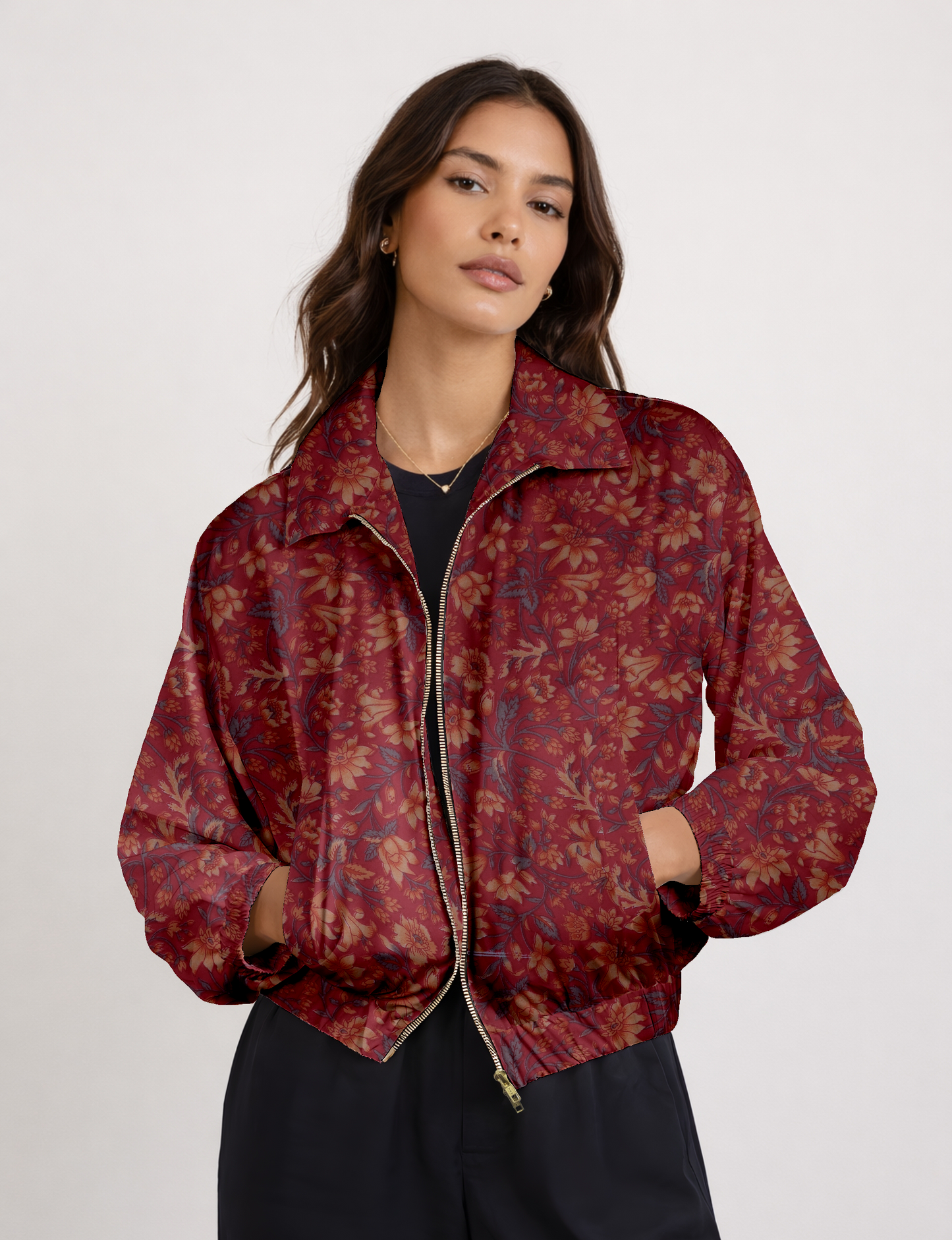 Women's cropped bomber jacket with twin metallic front zippers, welt pockets, elasticated hem and cuffs, and contrast sari print lining.