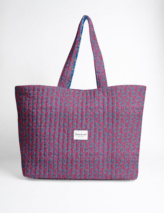 Quilted yellow tropical patterned beach bag with long handles and white label reading "I was a sari" front view