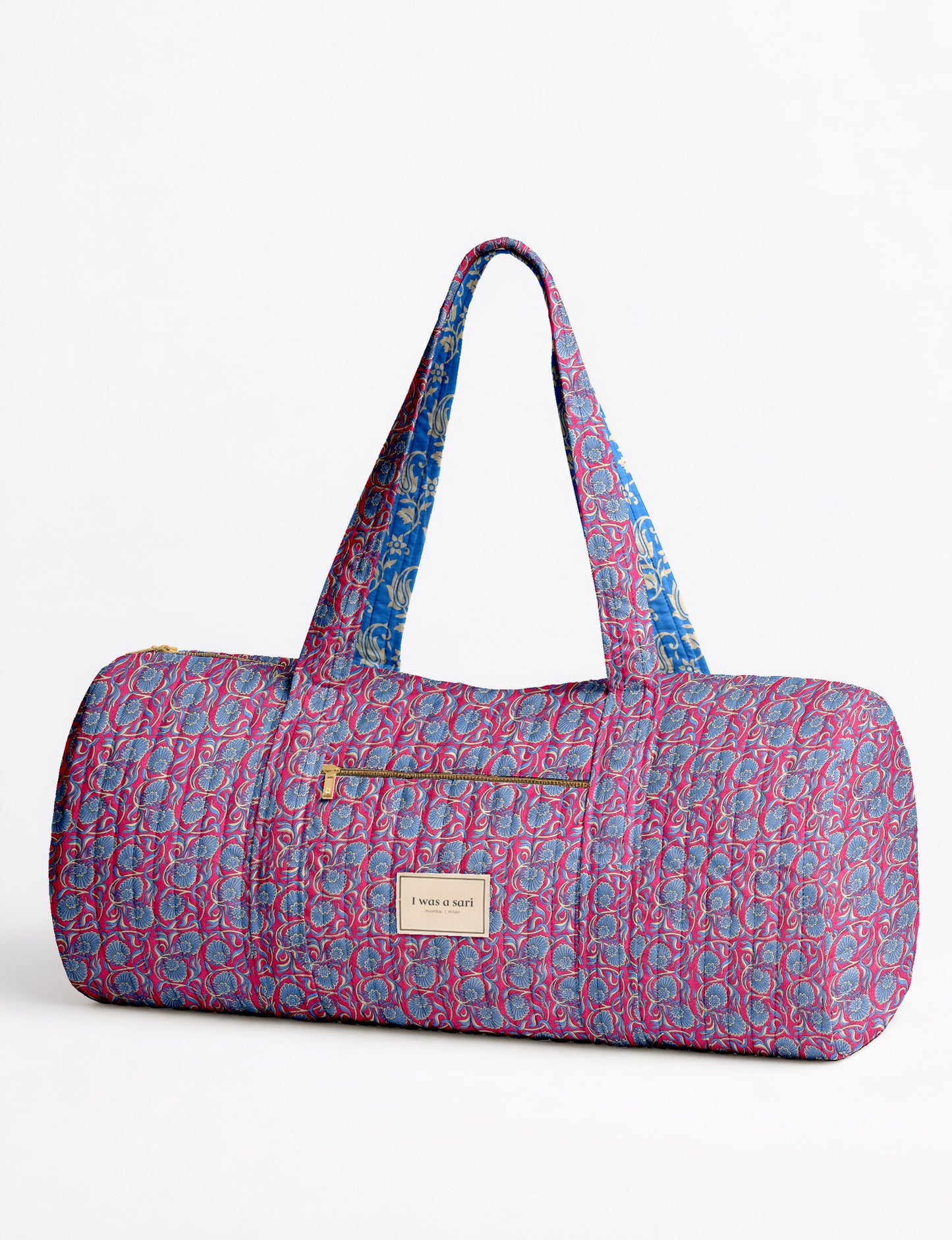 Brown paisley quilted bowling bag with dual handles, front zipper pocket, and "I was a sari" label on front side