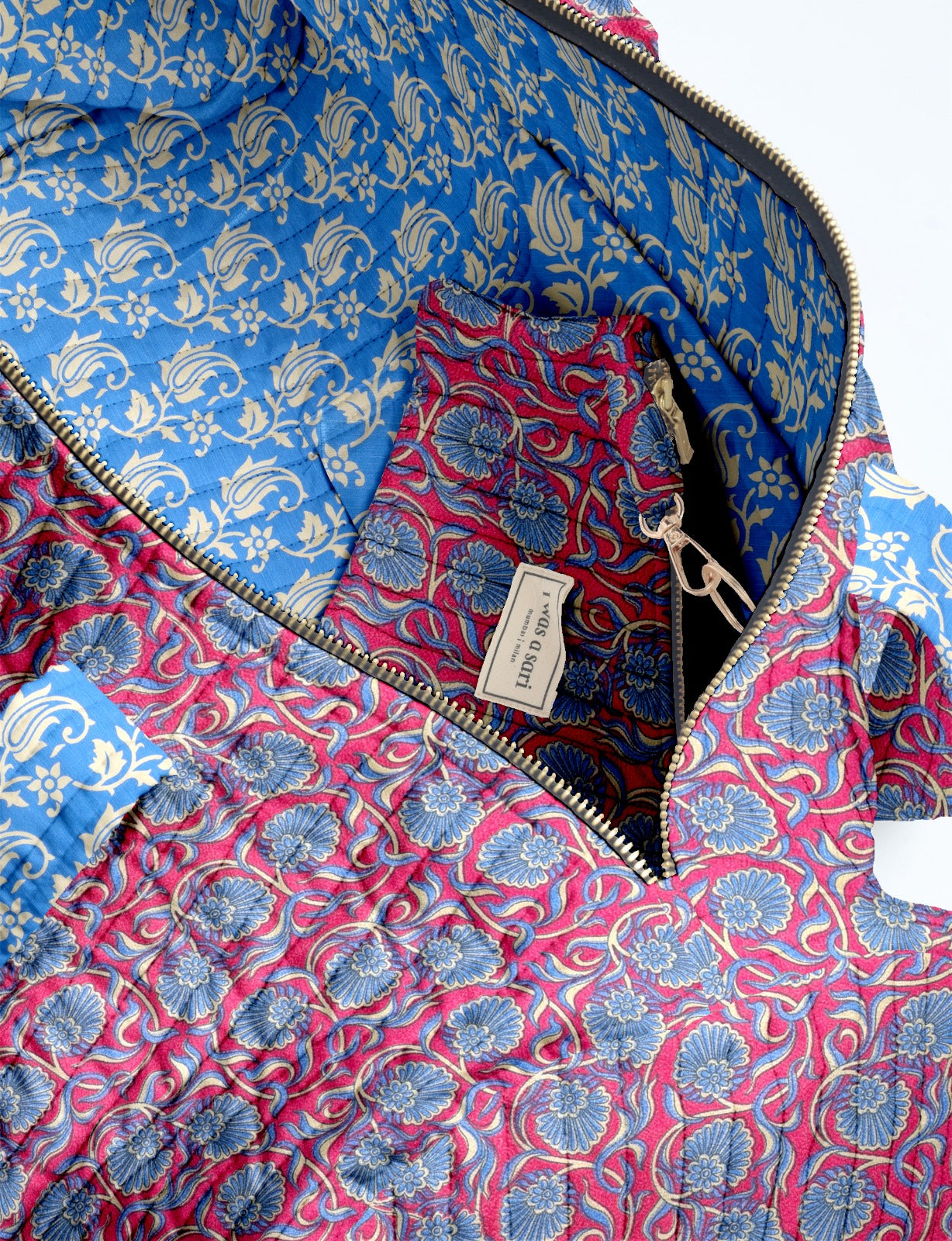 Quilted brown paisley bowling bag with gold zipper, floral interior lining, and interior key clip with label inside pocket