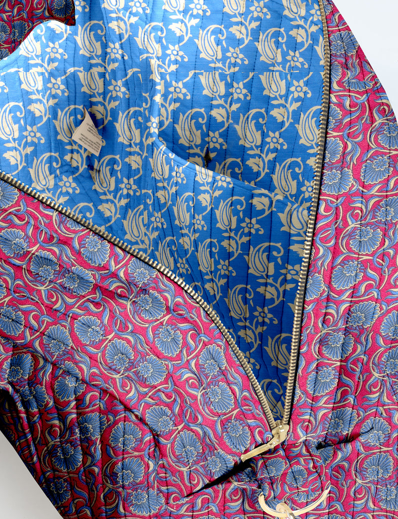 Brown quilted duffle bag with paisley pattern, front zip pocket, dual handles, and label reading "I was a sari"
