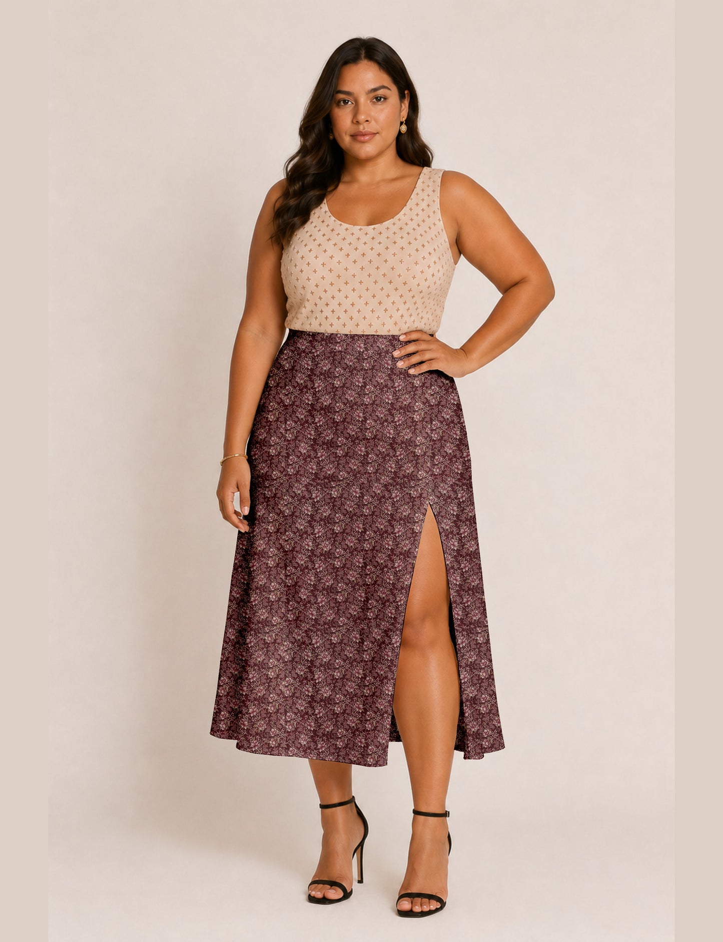Woman wearing a yellow and black micro patterned A-line skirt with front slit, paired with beige sleeveless top and black