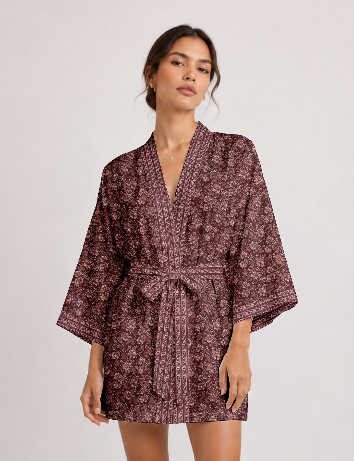 Short kimono robe with wrap front, V-neckline, wide sleeves, waist tie, and concealed skort detail.