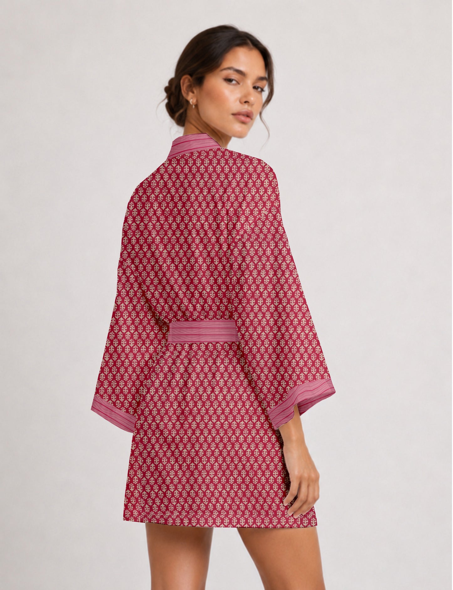 Short kimono robe with wrap front, V-neckline, wide sleeves, waist tie, and concealed skort detail.
