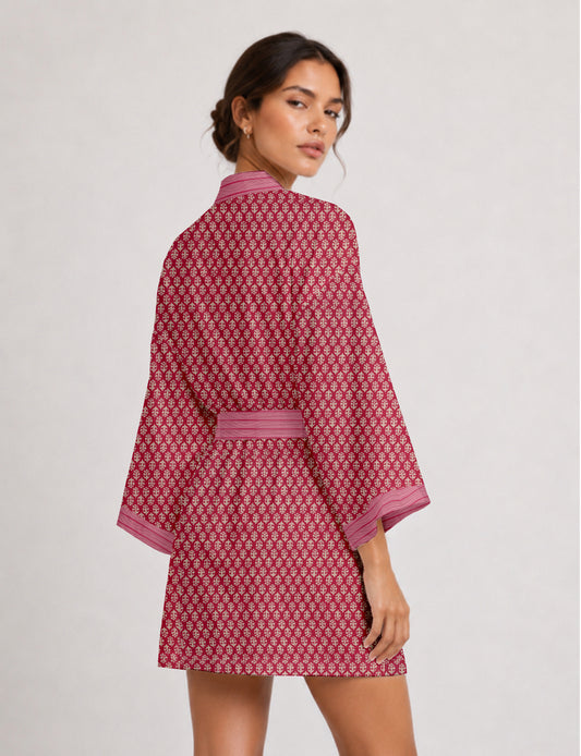 Short kimono robe with wrap front, V-neckline, wide sleeves, waist tie, and concealed skort detail.