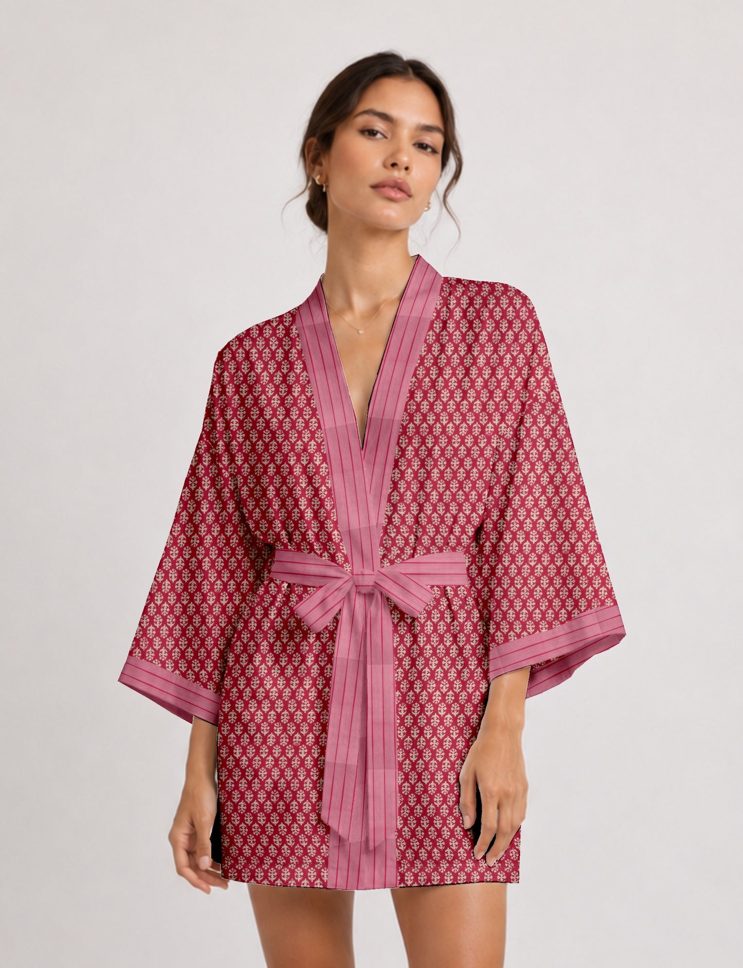 Short kimono robe with wrap front, V-neckline, wide sleeves, waist tie, and concealed skort detail.
