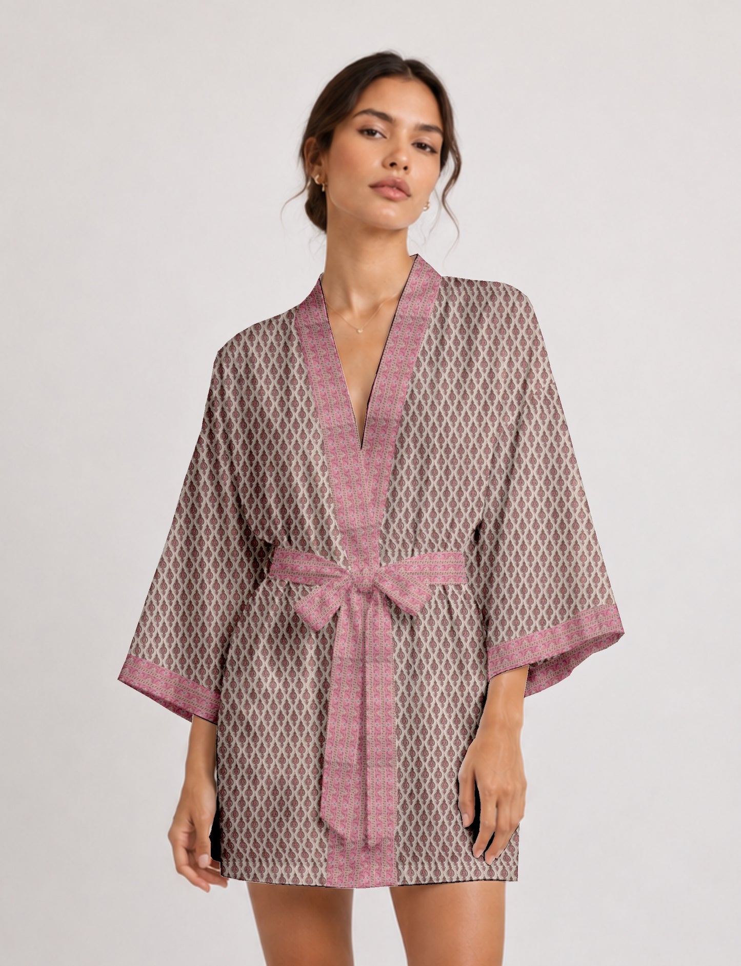 Short kimono robe with wrap front, V-neckline, wide sleeves, waist tie, and concealed skort detail.