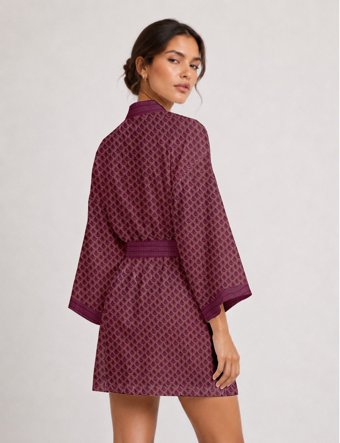 Short kimono robe with wrap front, V-neckline, wide sleeves, waist tie, and concealed skort detail.