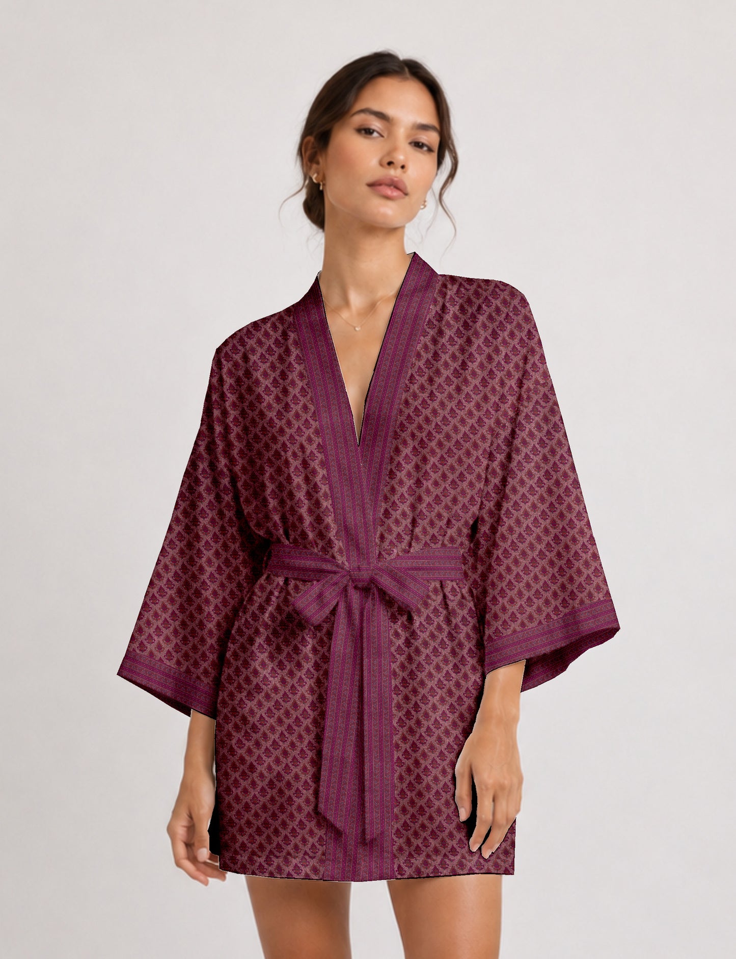 Short kimono robe with wrap front, V-neckline, wide sleeves, waist tie, and concealed skort detail.