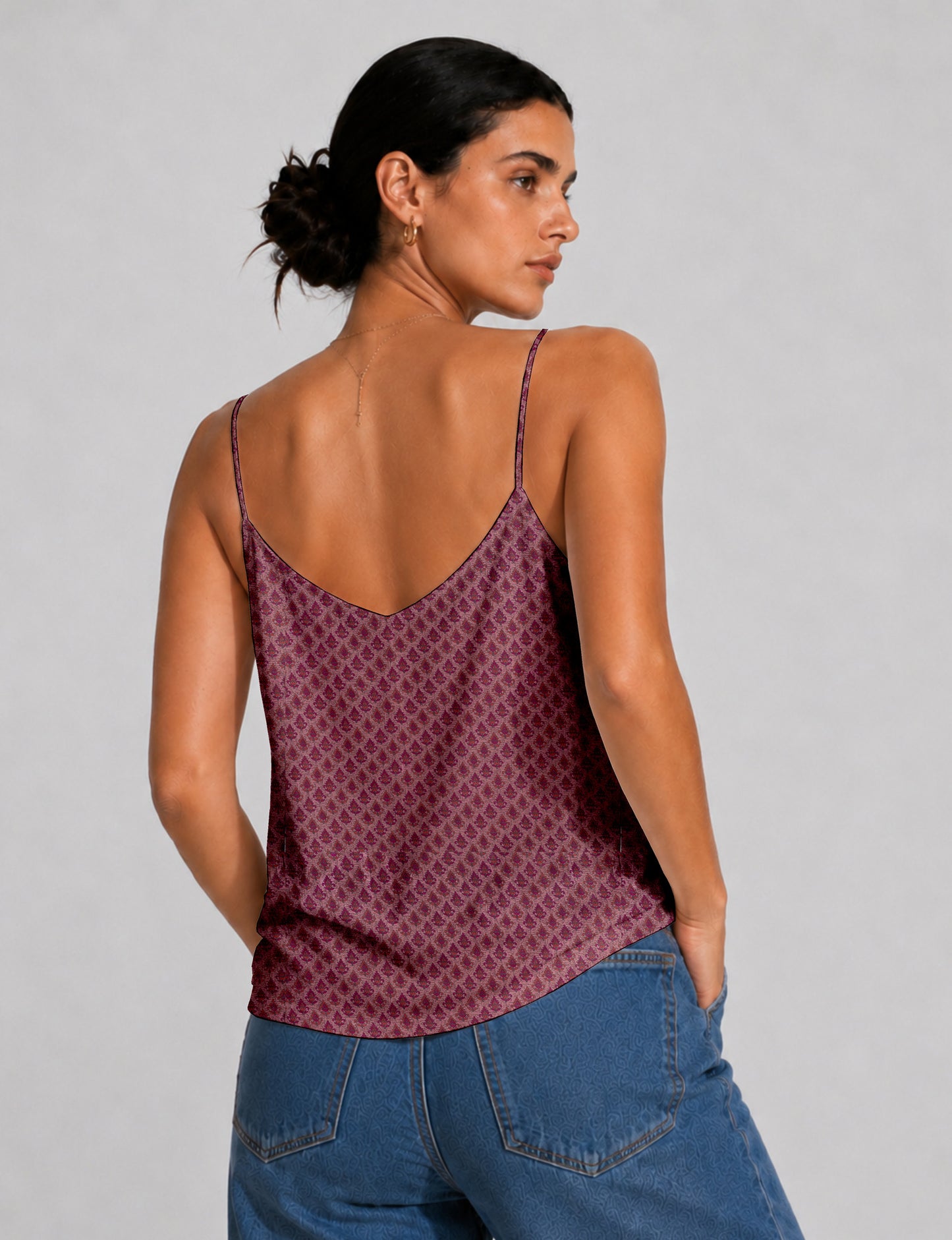 Women's sleeveless slip top with a relaxed straight fit, soft V-neckline, deep V-back, and delicate spaghetti straps.