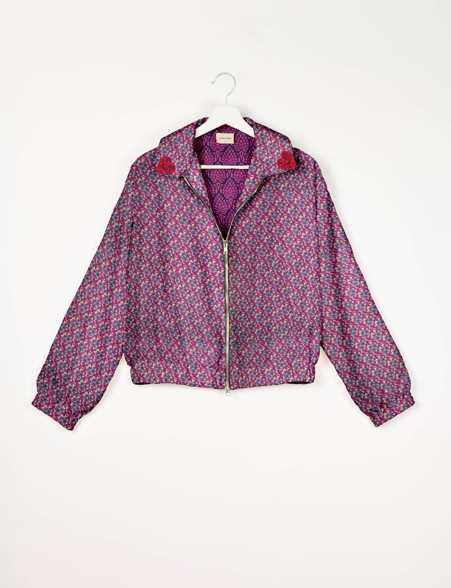 Make a bold statement with our Heart Drop Earrings, a symbol of conscious luxury and ethical fashion. Handcrafted using the intricate Aari embroidery technique, these earrings are made from upcycled sari fabric, embracing slow fashion and zero waste clothing. Elevate your look with sustainable apparel that supports fair trade fashion while reducing textile waste. Choose eco-friendly fashion that speaks of love, artistry, and responsibility.