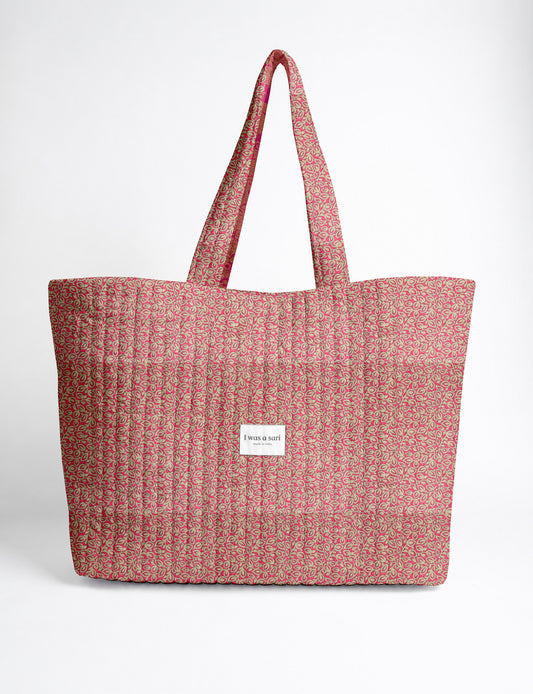 Quilted yellow tropical patterned beach bag with long handles and white label reading "I was a sari" front view