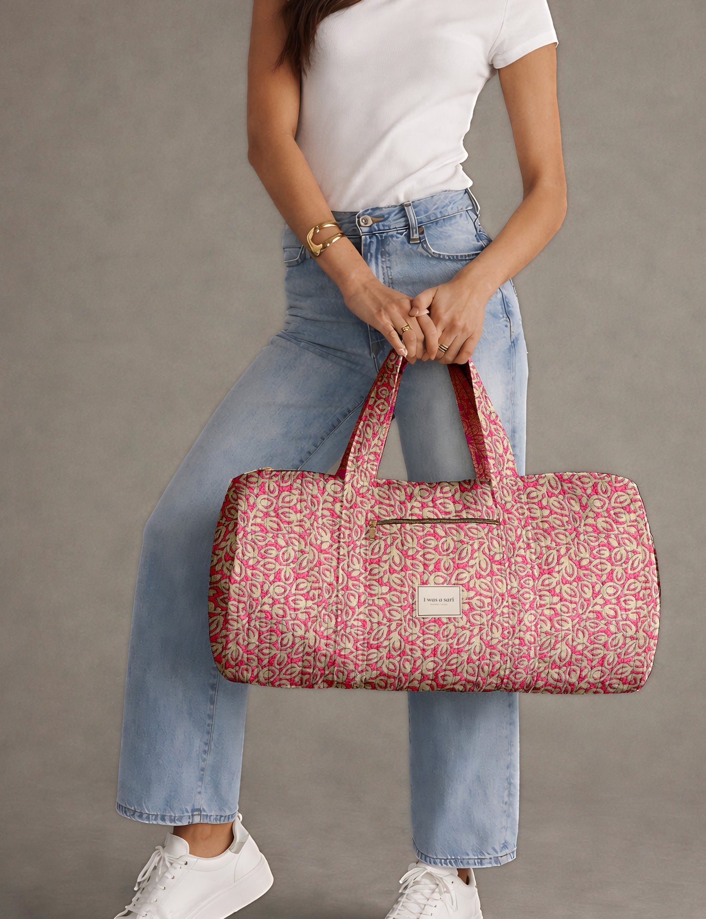 Brown paisley quilted bowling bag with dual handles, front zipper pocket, and "I was a sari" label on front side