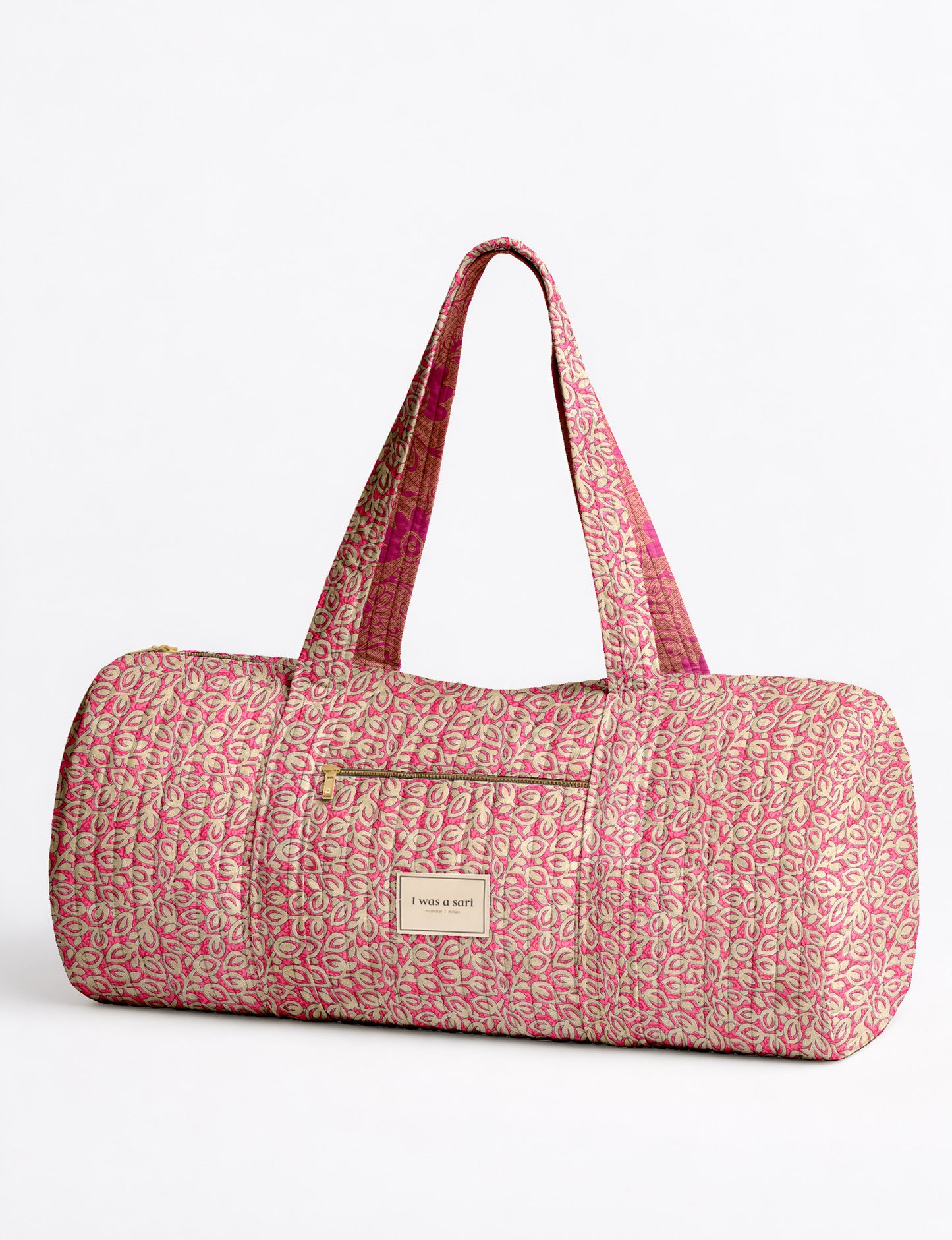 Brown paisley quilted bowling bag with front zipper pocket, held by person wearing white shirt and light blue jeans