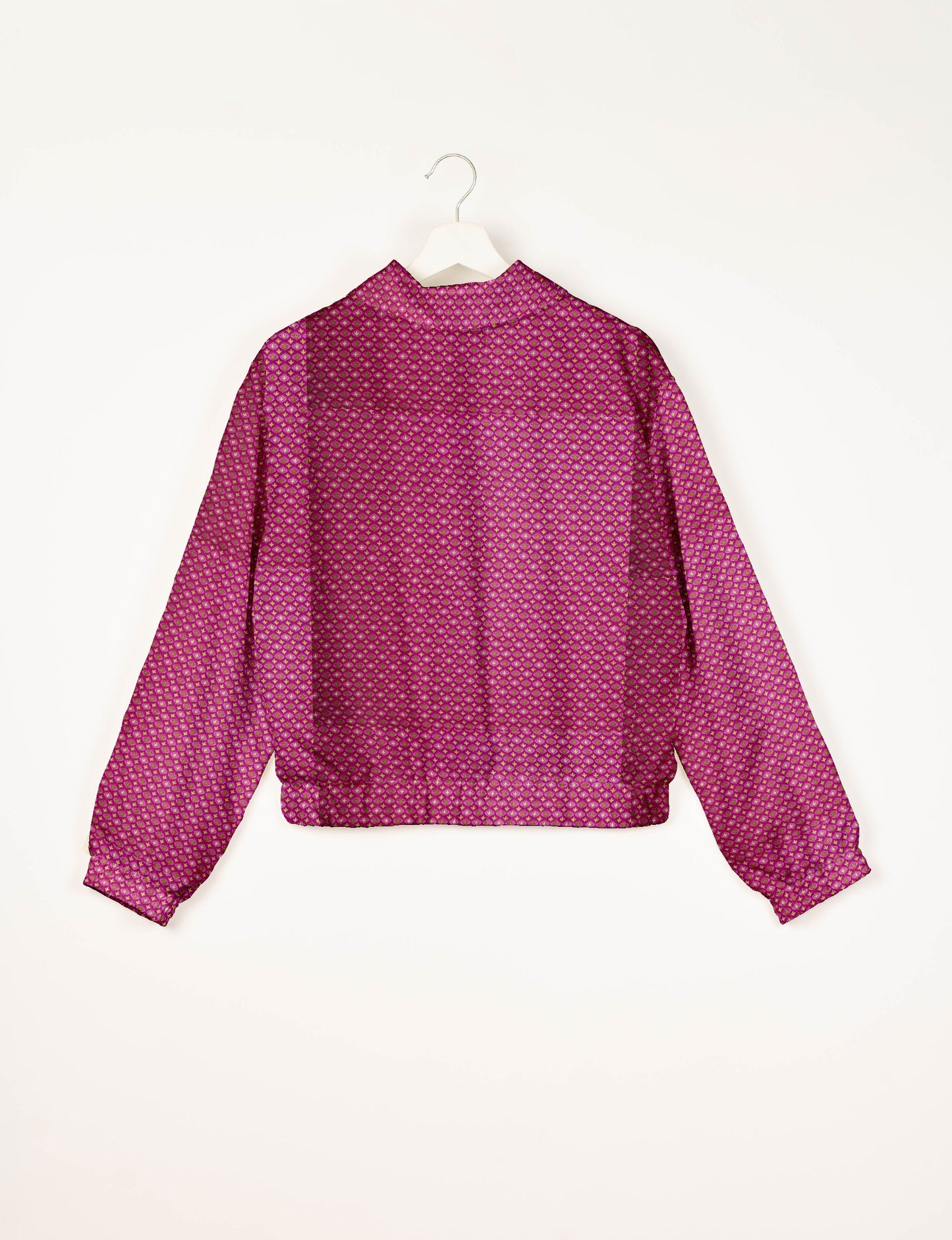 Upcycled Bomber Jacket made from recycled sari materials, featuring a cute cropped shape, elasticated hem and cuffs, and contrast sari print lining. Sustainable apparel promoting eco-friendly fashion and ethical clothing.