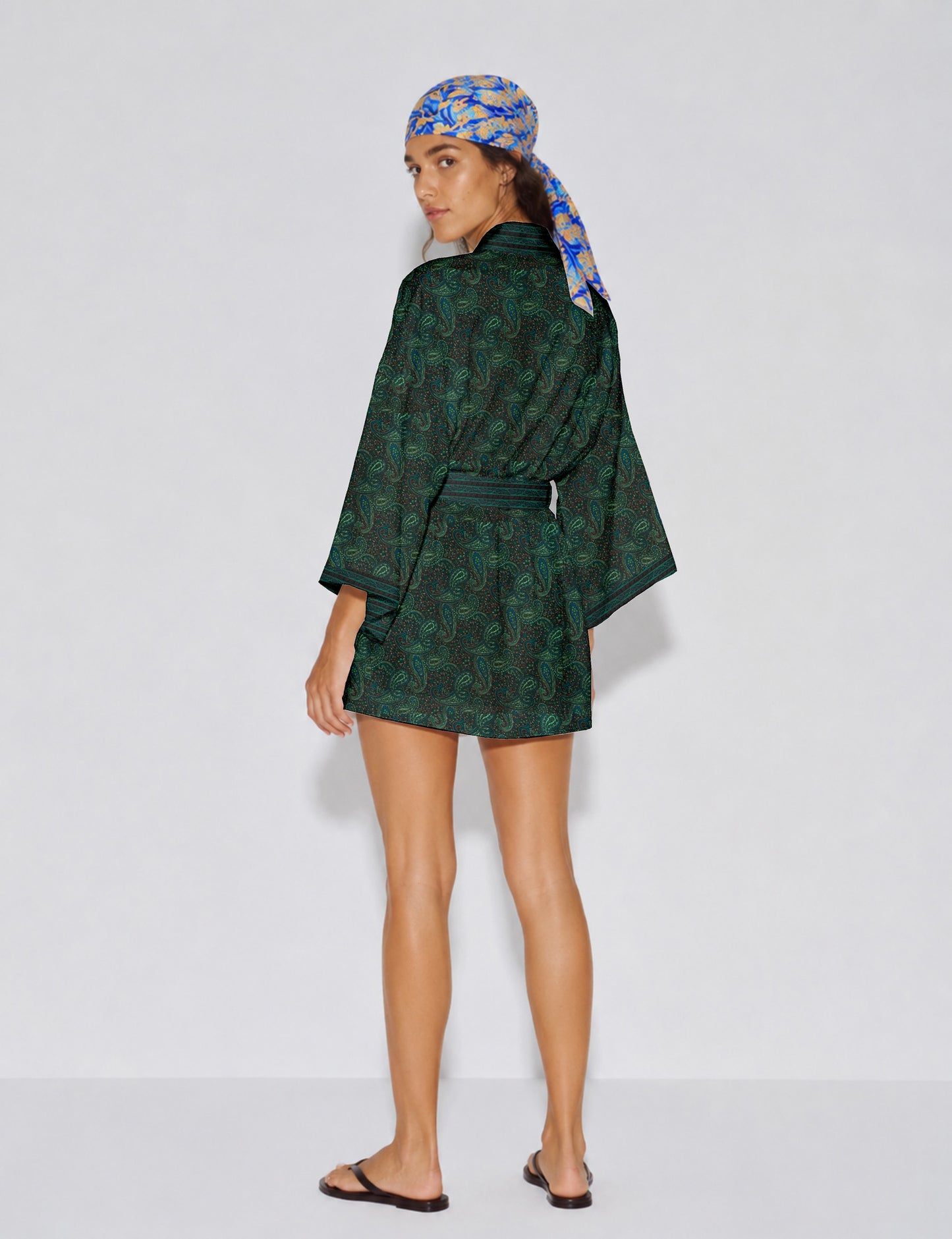 Short kimono robe with wrap front, V-neckline, wide sleeves, waist tie, and concealed skort detail.